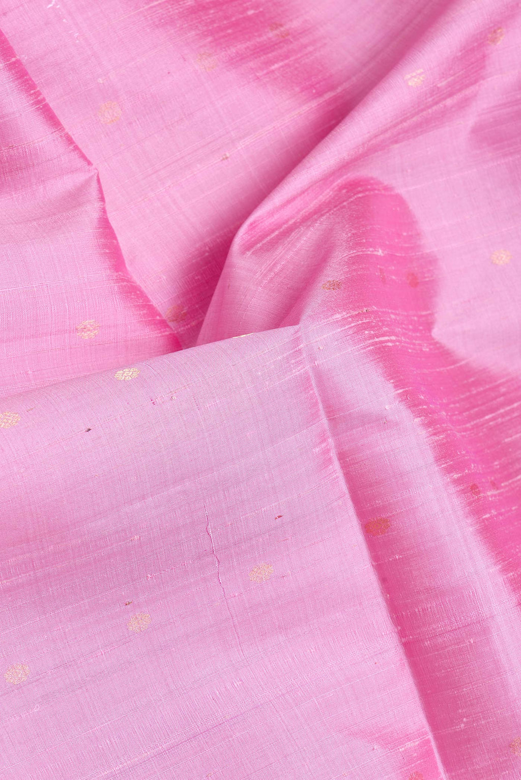 Close up of Pink Dual Tone Raw Silk Saree with Zari Butta on the body and Zari Border.  displaying folds
