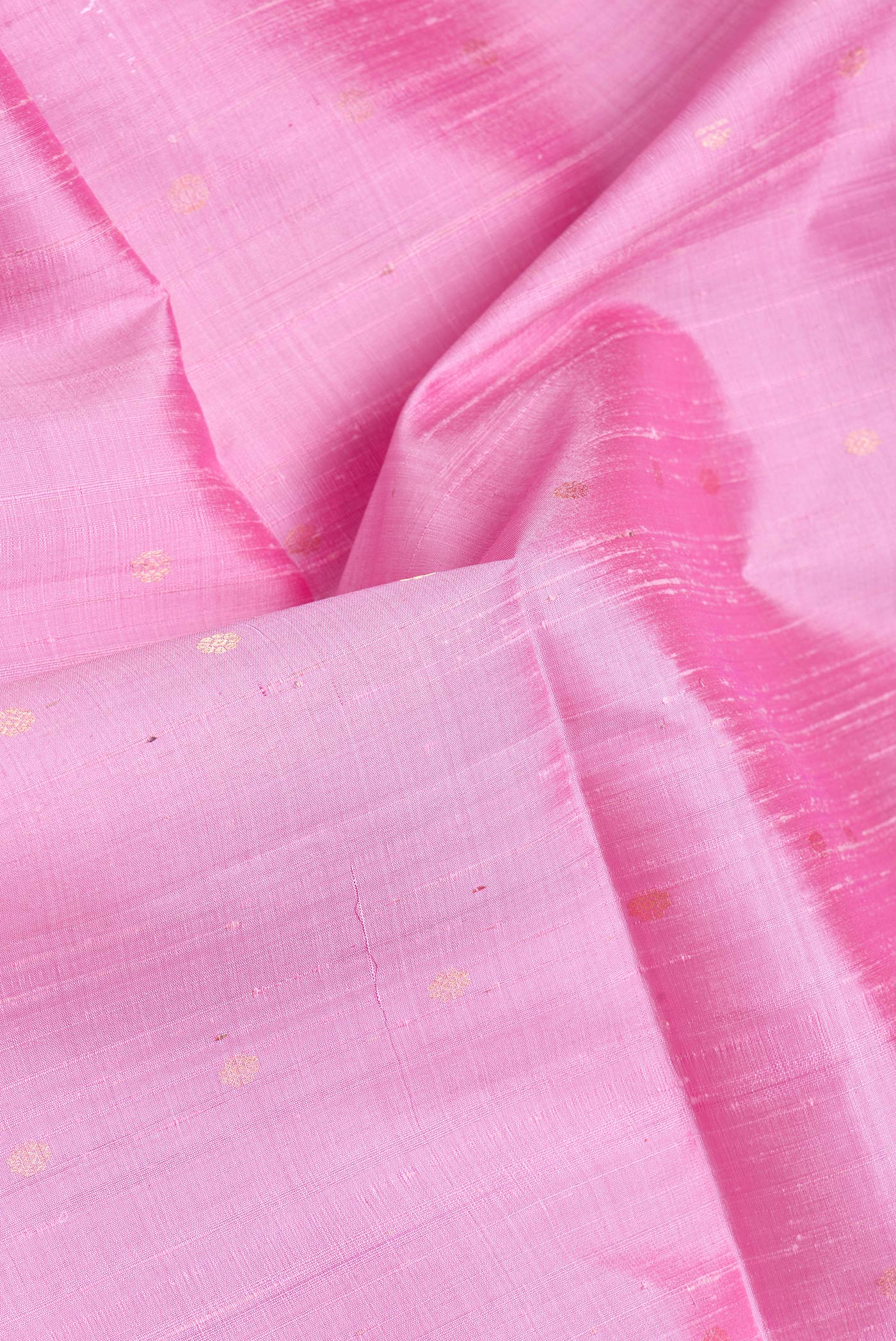 Close up of Pink Dual Tone Raw Silk Saree with Zari Butta on the body and Zari Border.  displaying folds
