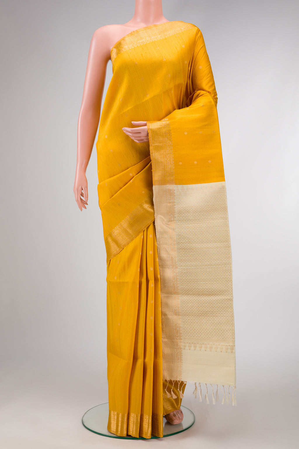 Mustard Dual Tone Raw Silk Saree with Zari Butta on the body and Zari Border.  displayed on a mannequin