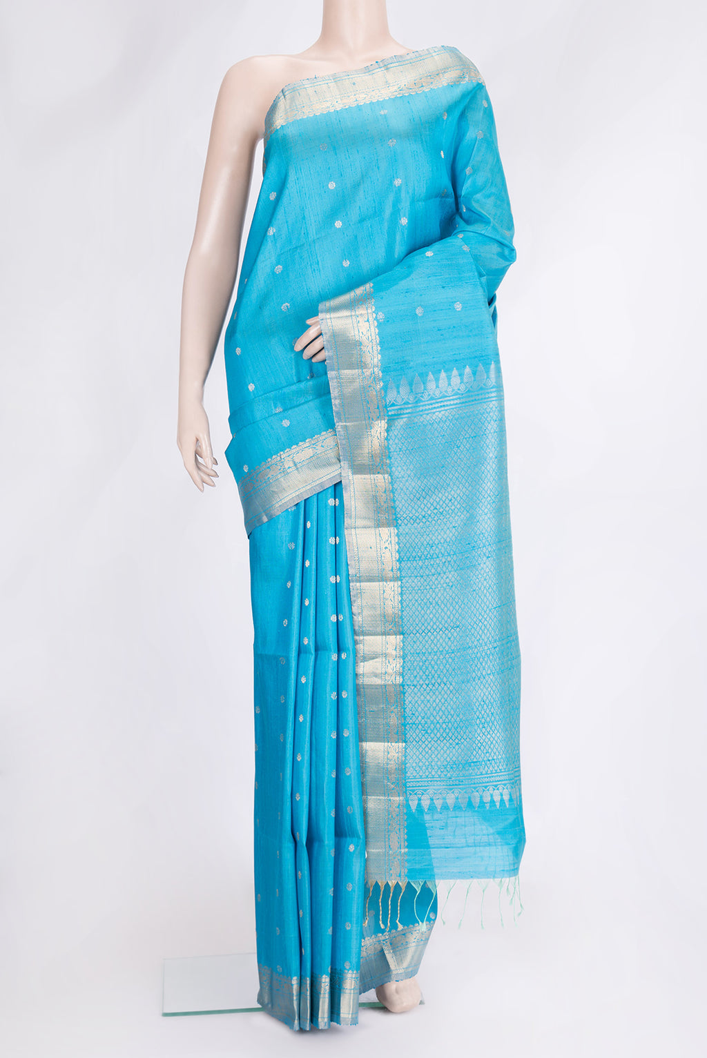 Sky Blue Dual Tone Raw Silk Saree with Zari Butta on the body and Zari Border.  displayed on a mannequin