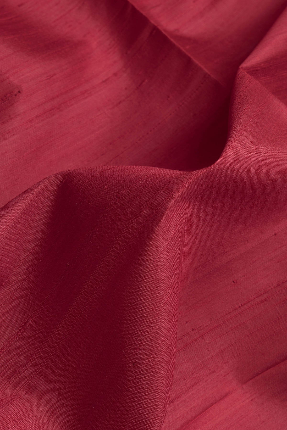 Close up of Maroon Dual Tone Raw Silk Saree with Plain Body and Zari Border.  displaying folds