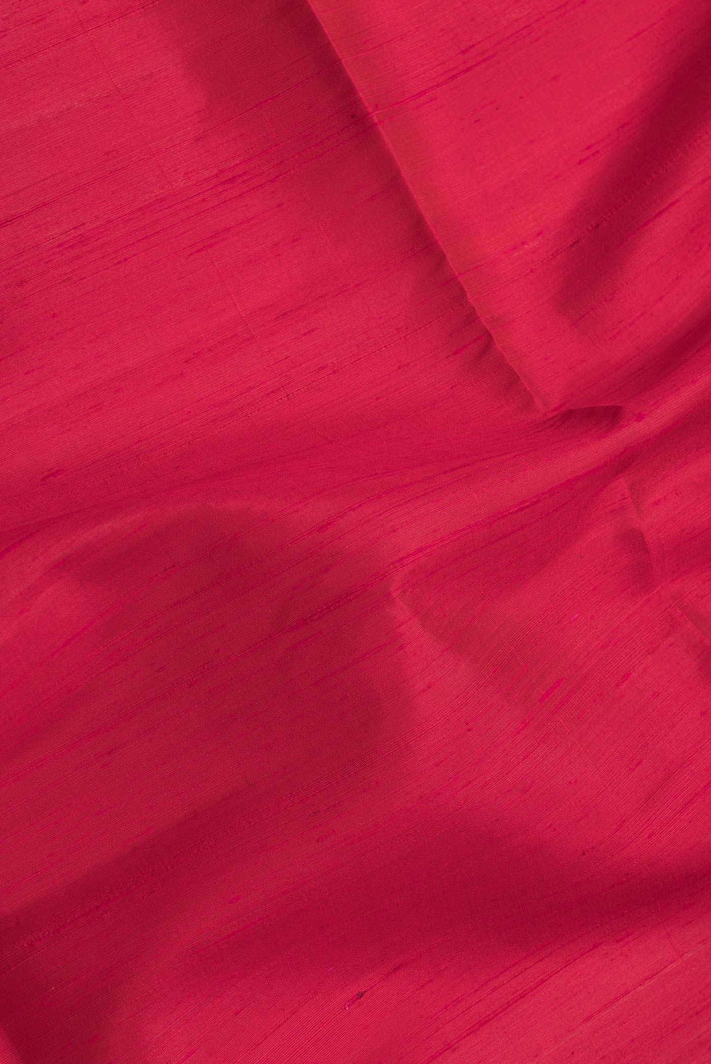 Close up of Dark Pink Dual Tone Raw Silk Saree with Plain Body and Zari Border.  displaying folds