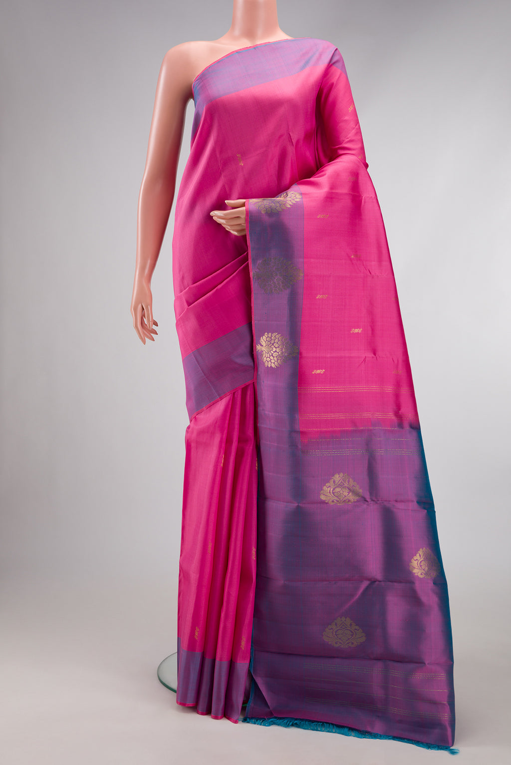 Pink Kanchipuram Silk Saree with Zari Butta on the body and Zari Border.  displayed on a mannequin