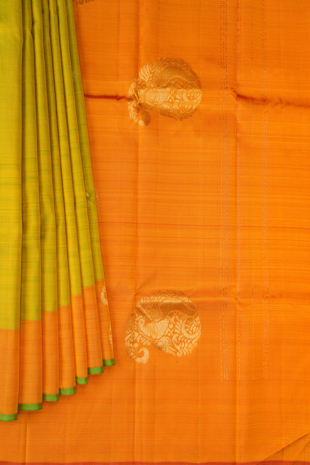 Pleats and pallu of Parrot Green Kanchipuram Silk Saree with Zari Butta on the body and Zari Border. 