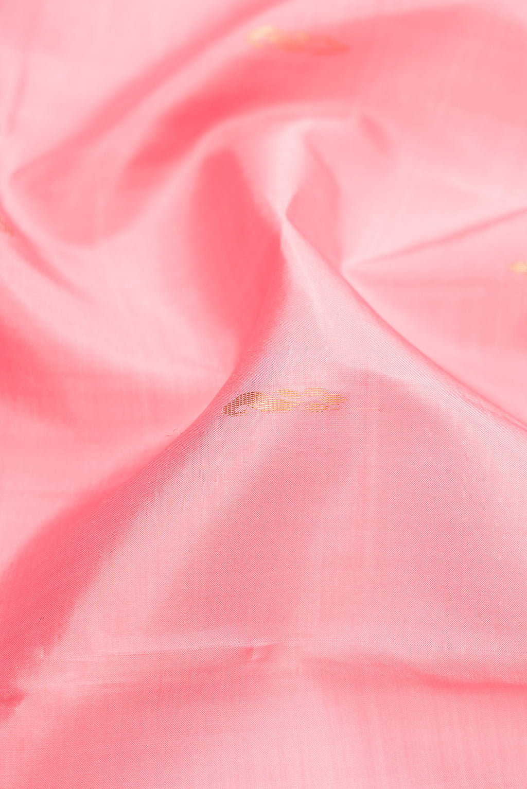 Close up of Rose pink Kanchipuram Silk Saree with Zari Butta on the body and Fancy Border.  displaying folds