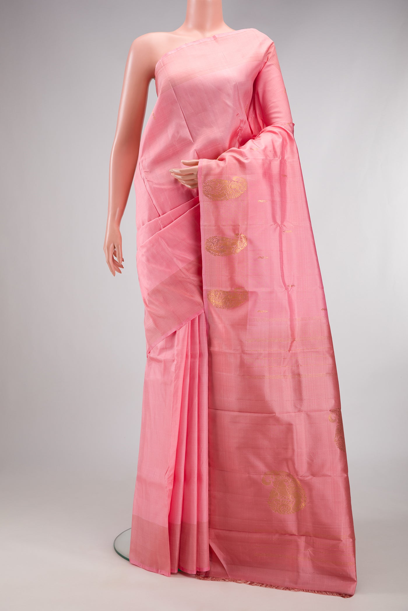 Rose pink Kanchipuram Silk Saree with Zari Butta on the body and Fancy Border.  displayed on a mannequin