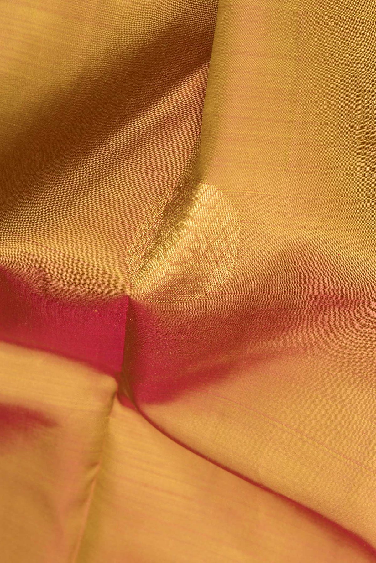 Close up of Pure Silk Rust with Mustard Color Kanchipuram Saree with Zari Butta on the body and Fancy Border.  displaying folds