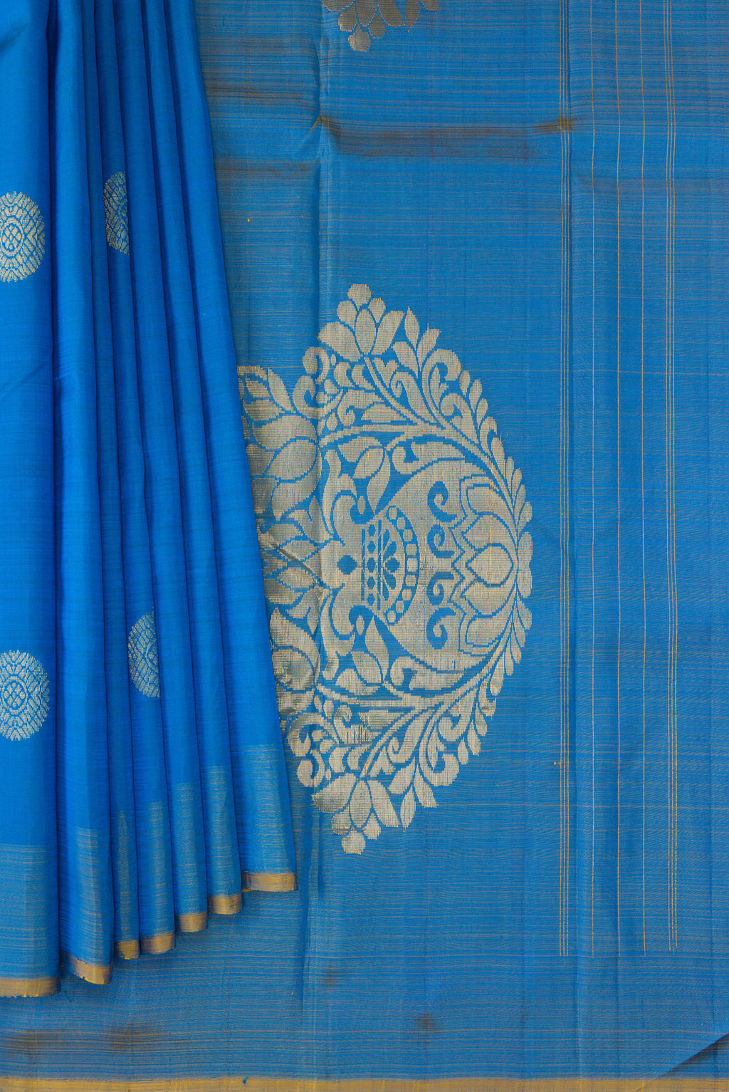 Pleats and pallu of Peacock Blue Kanchipuram Silk Saree with Zari Butta on the body and Zari Border. 