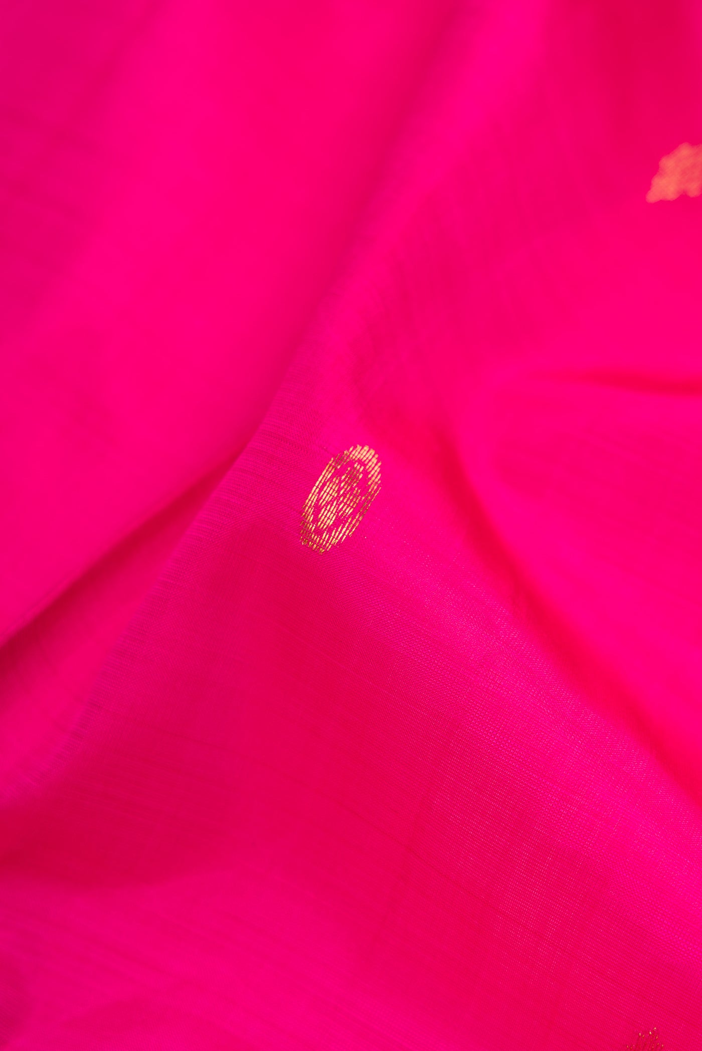 Close up of Pink Kanjivaram Silk Saree with Zari Butta on the body and Zari Border.  displaying folds