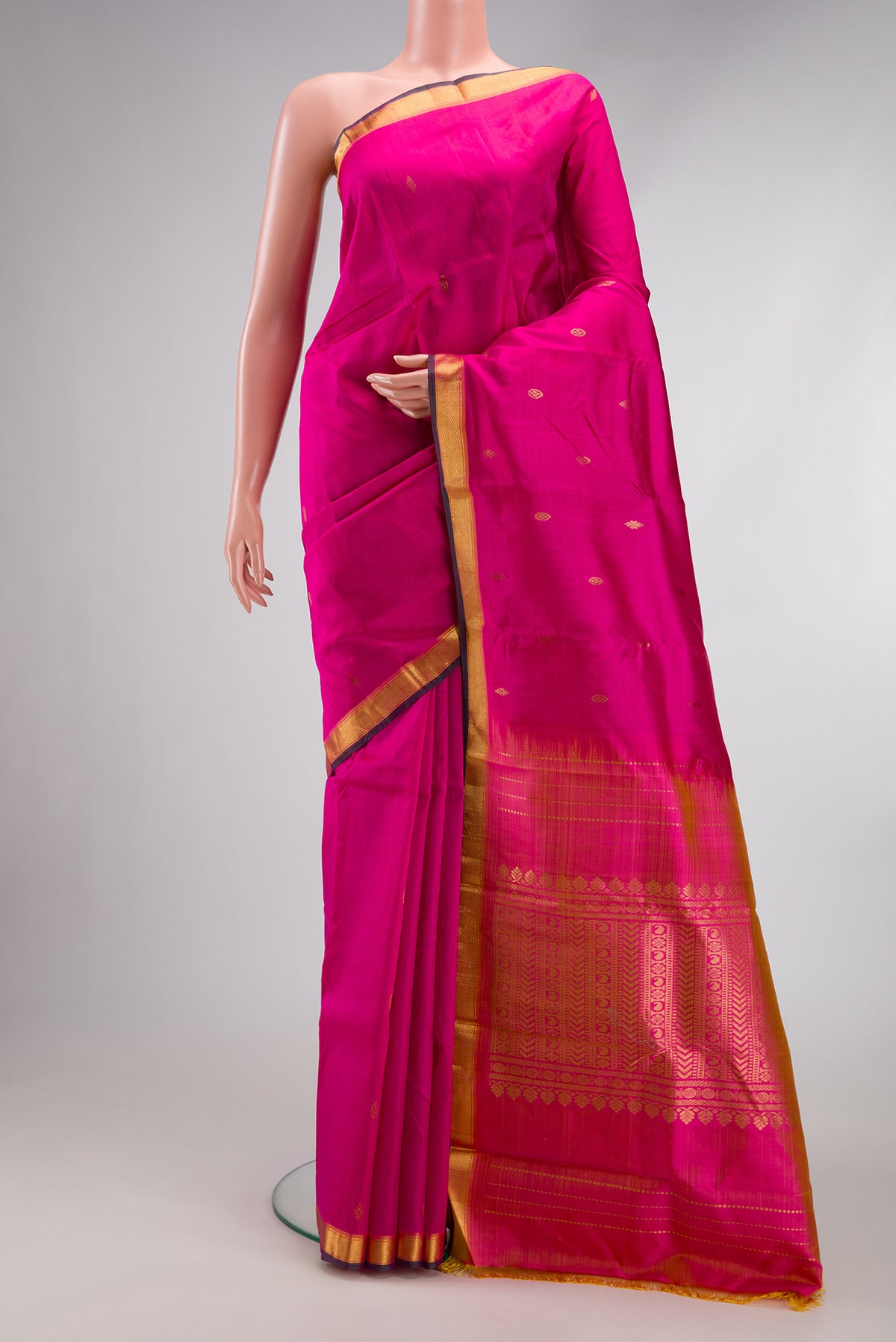 Pink Kanjivaram Silk Saree with Zari Butta on the body and Zari Border.  displayed on a mannequin