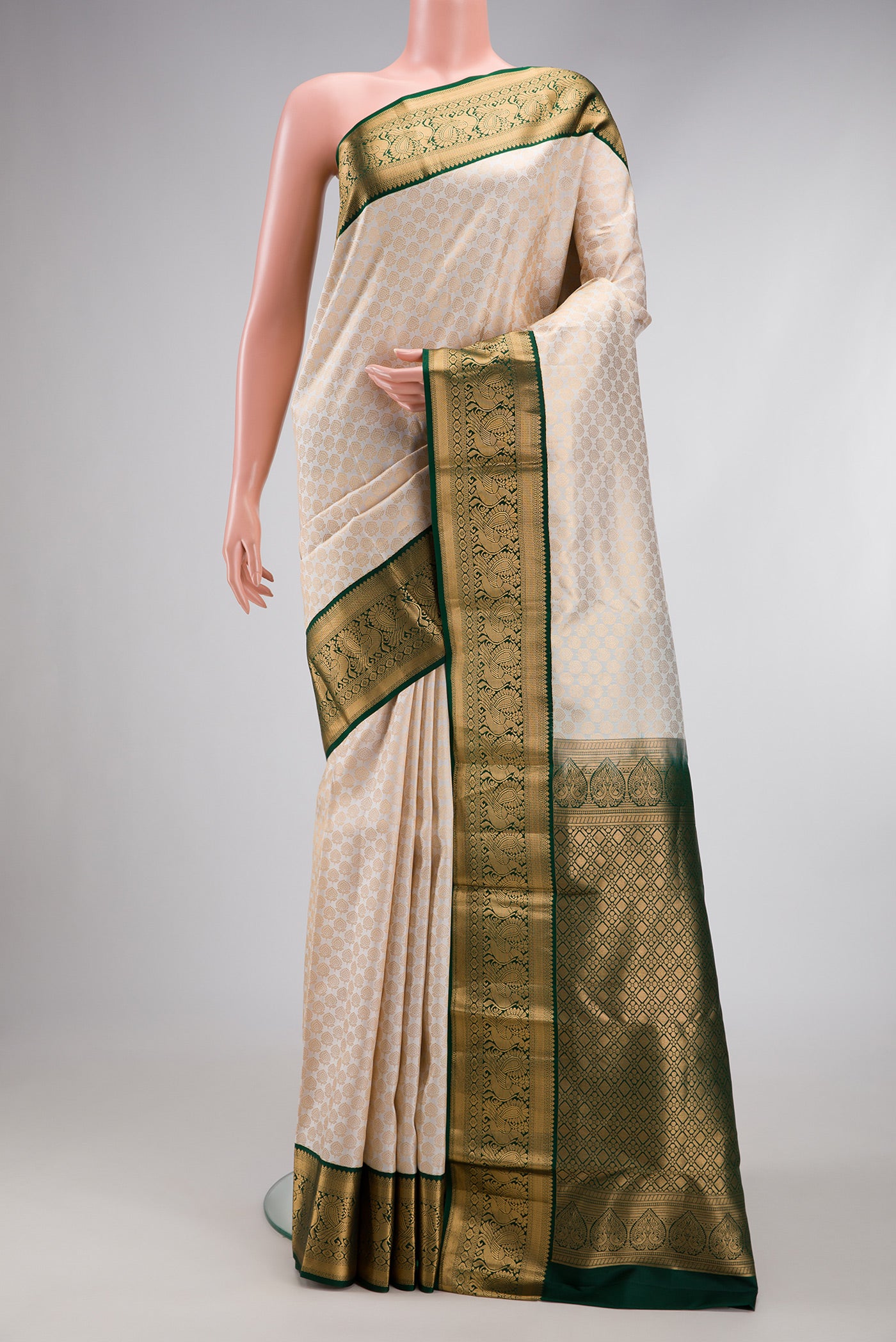 Off White Kanjivaram Silk Saree with Zari Brocade on the body and Zari Border.  displayed on a mannequin