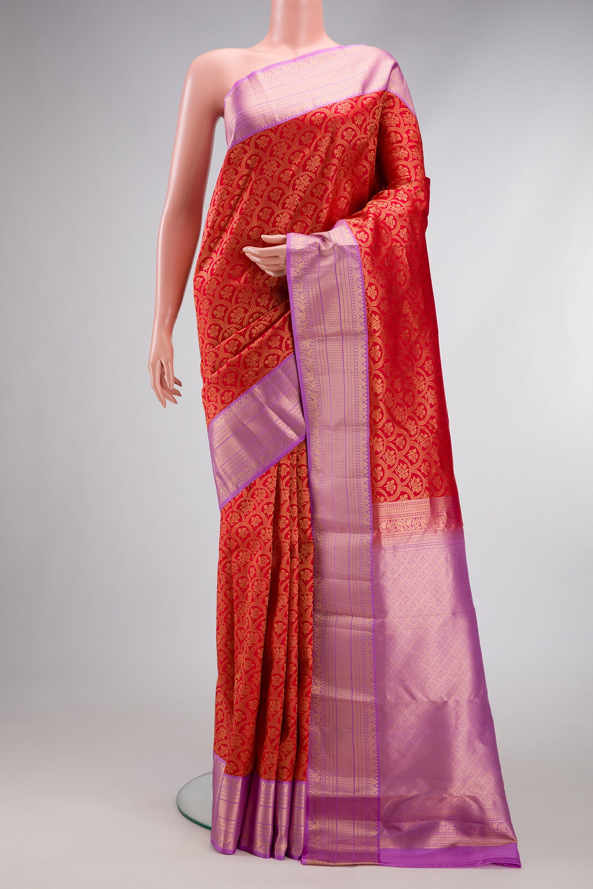 Red Kanjivaram Silk Saree with Zari Brocade on the body and Zari Border.  displayed on a mannequin