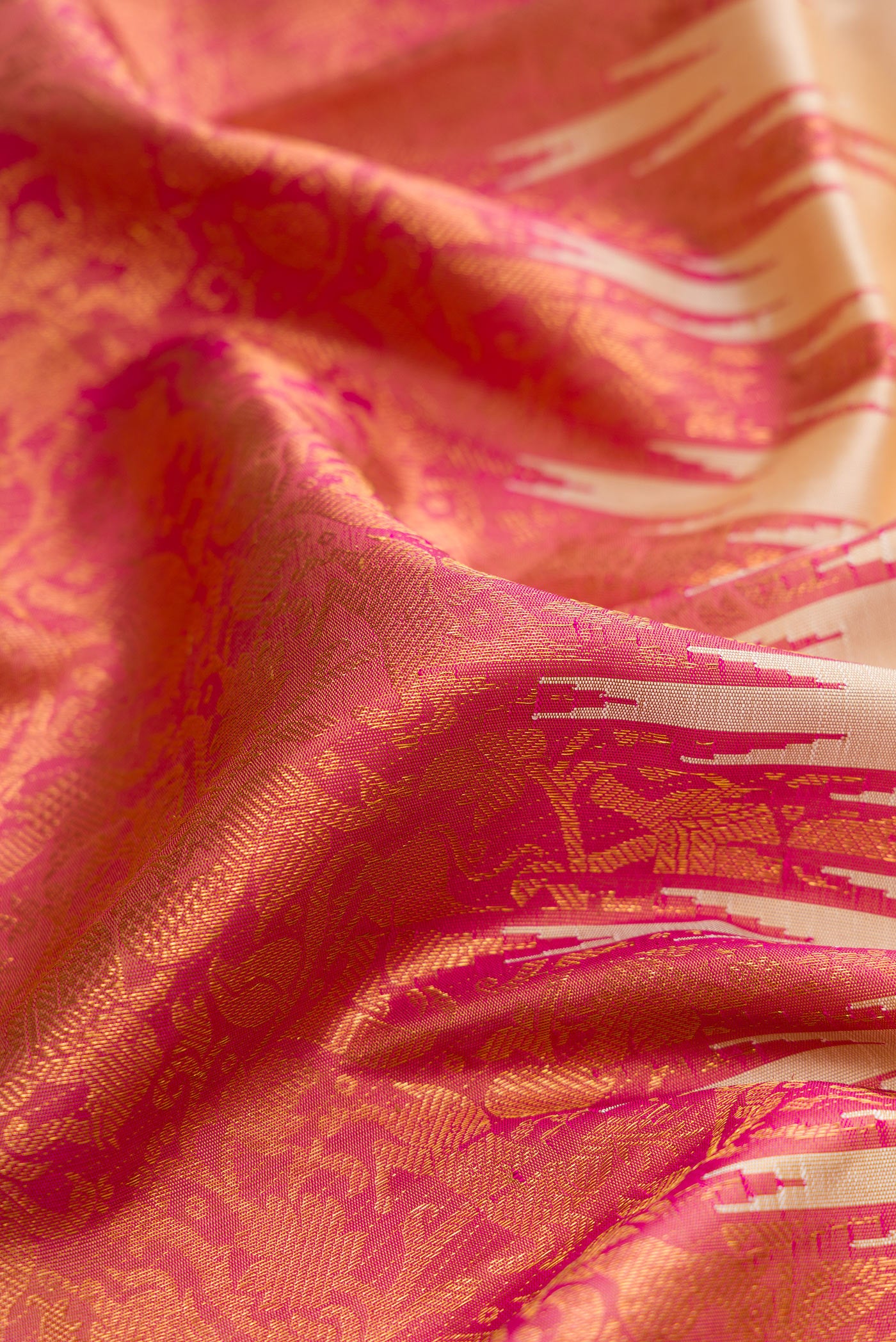 Close up of Beige Dual Tone Kanchipuram Silk Saree with Plain Body and Rising Temple Border.  displaying folds