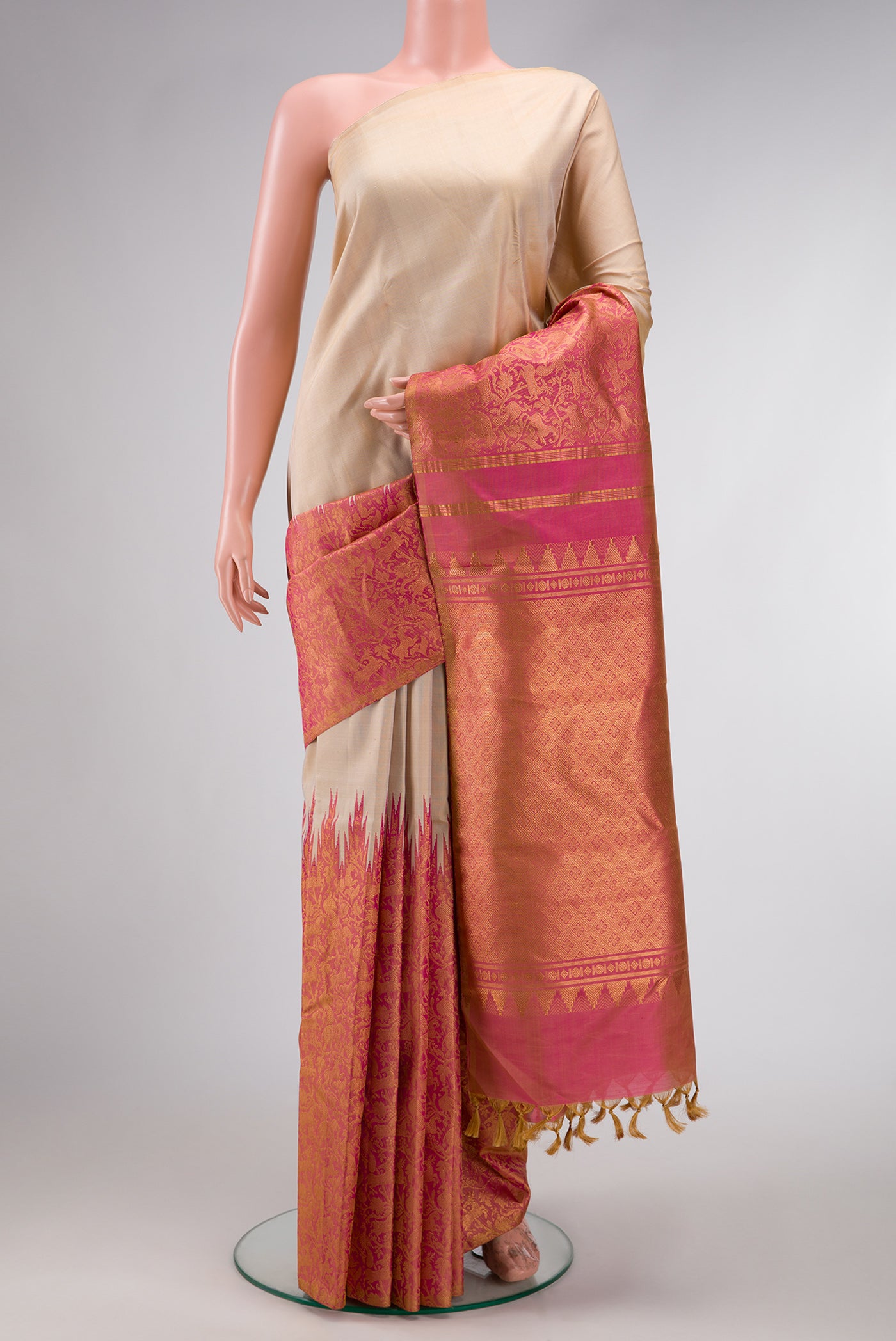 Beige Dual Tone Kanchipuram Silk Saree with Plain Body and Rising Temple Border.  displayed on a mannequin