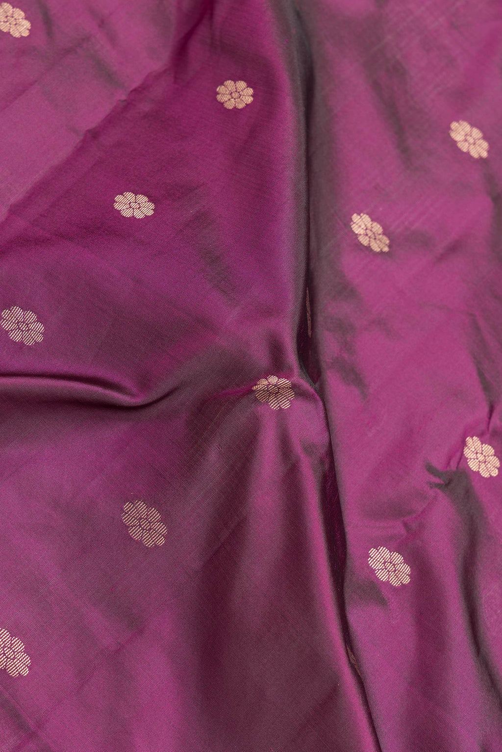 Close up of Magenta Dual Tone Blended Paithani Silk Saree with Zari Butta on the body and Zari Border.  displaying folds