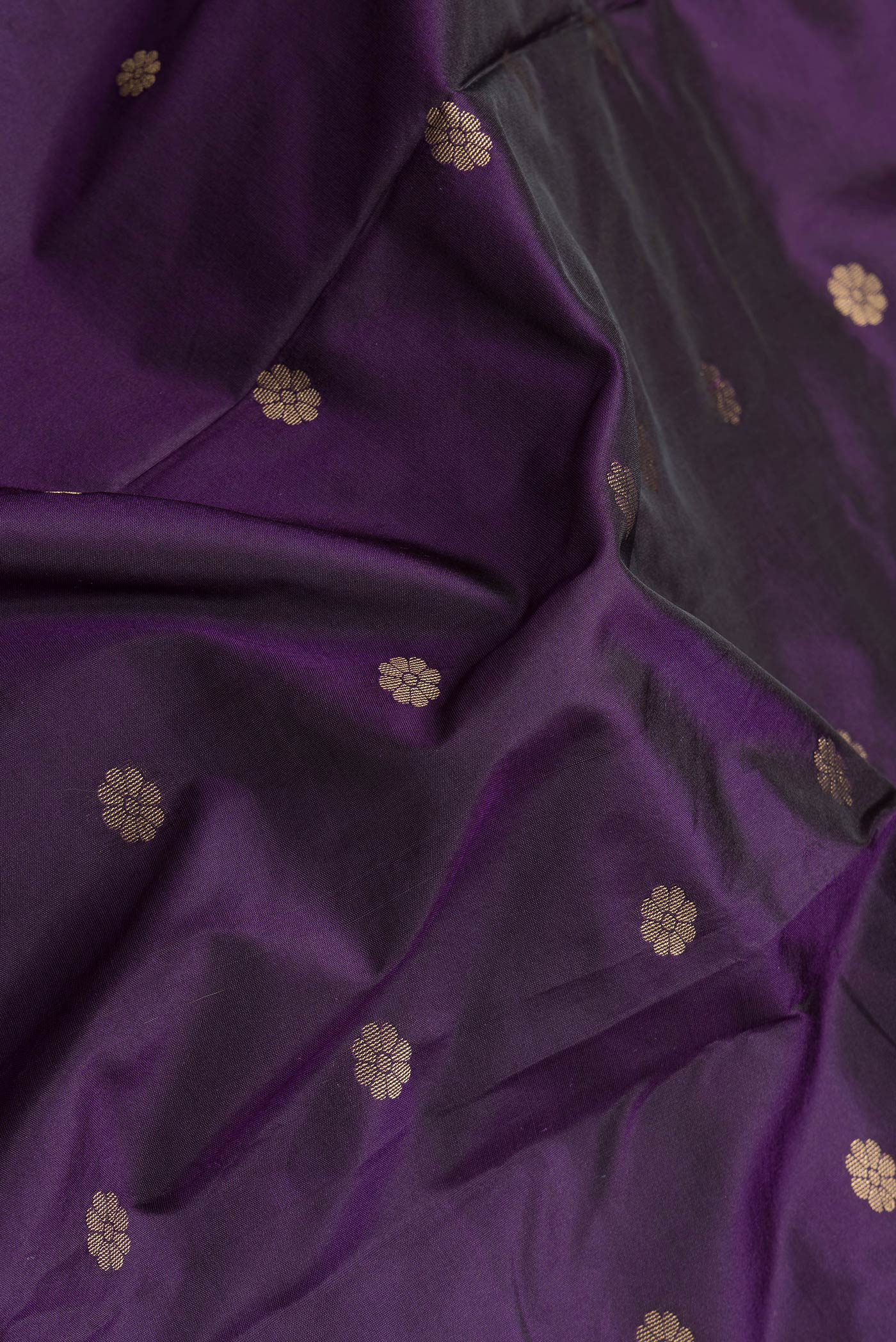 Close up of Violet Dual Tone Paithani Silk Saree with Zari Butta on the body and Zari Border.  displaying folds