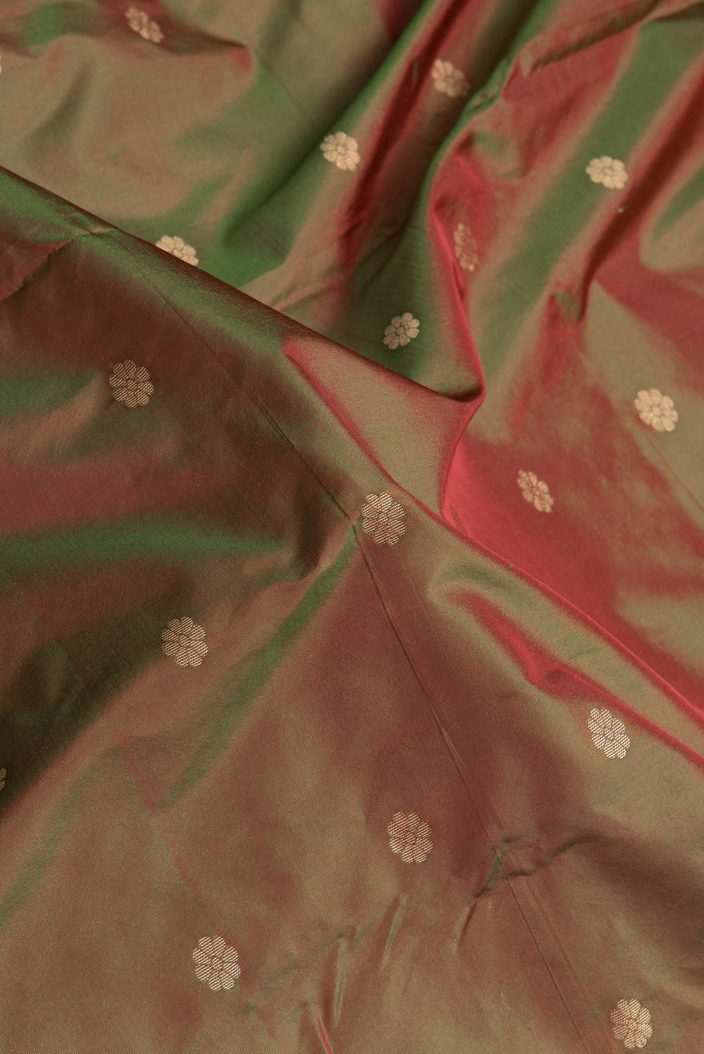 Close up of Mehandi Green Dual Tone Paithani Silk Saree with Zari Butta on the body and Zari Border.  displaying folds