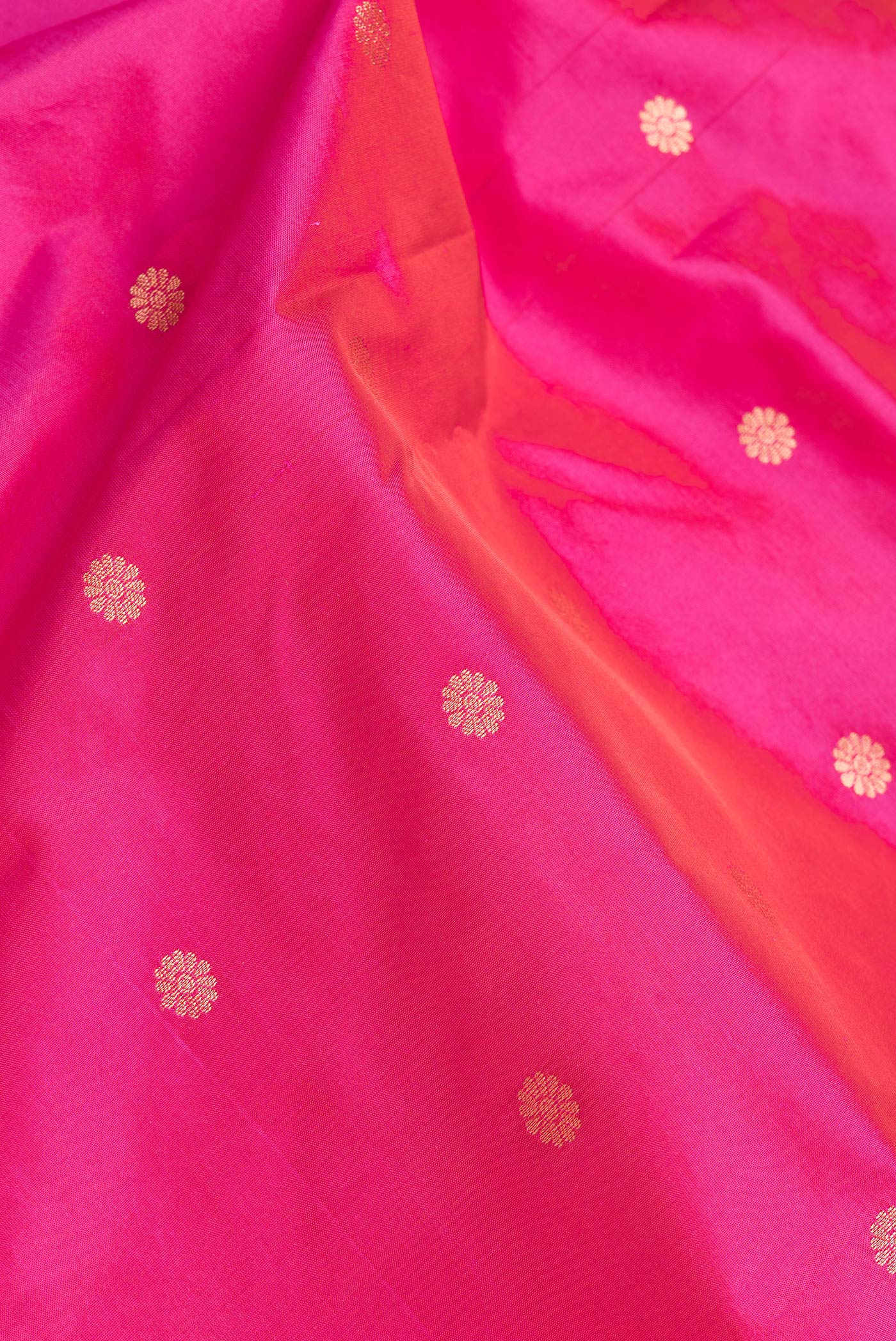 Close up of Dark Pink Dual Tone Paithani Silk Saree with Zari Butta on the body and Zari Border.  displaying folds
