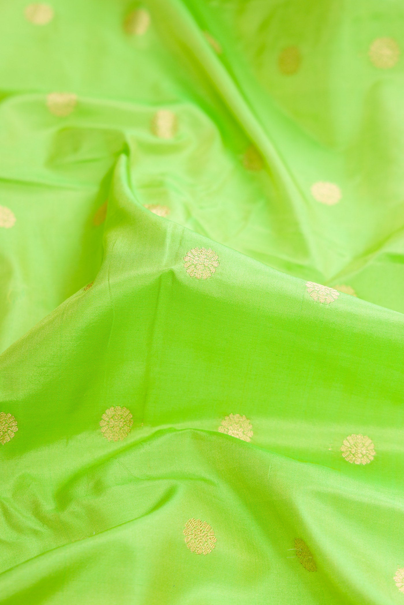 Close up of Parrot Green Dual Tone Blended Paithani Silk Saree with Zari Butta on the body and Zari Border.  displaying folds