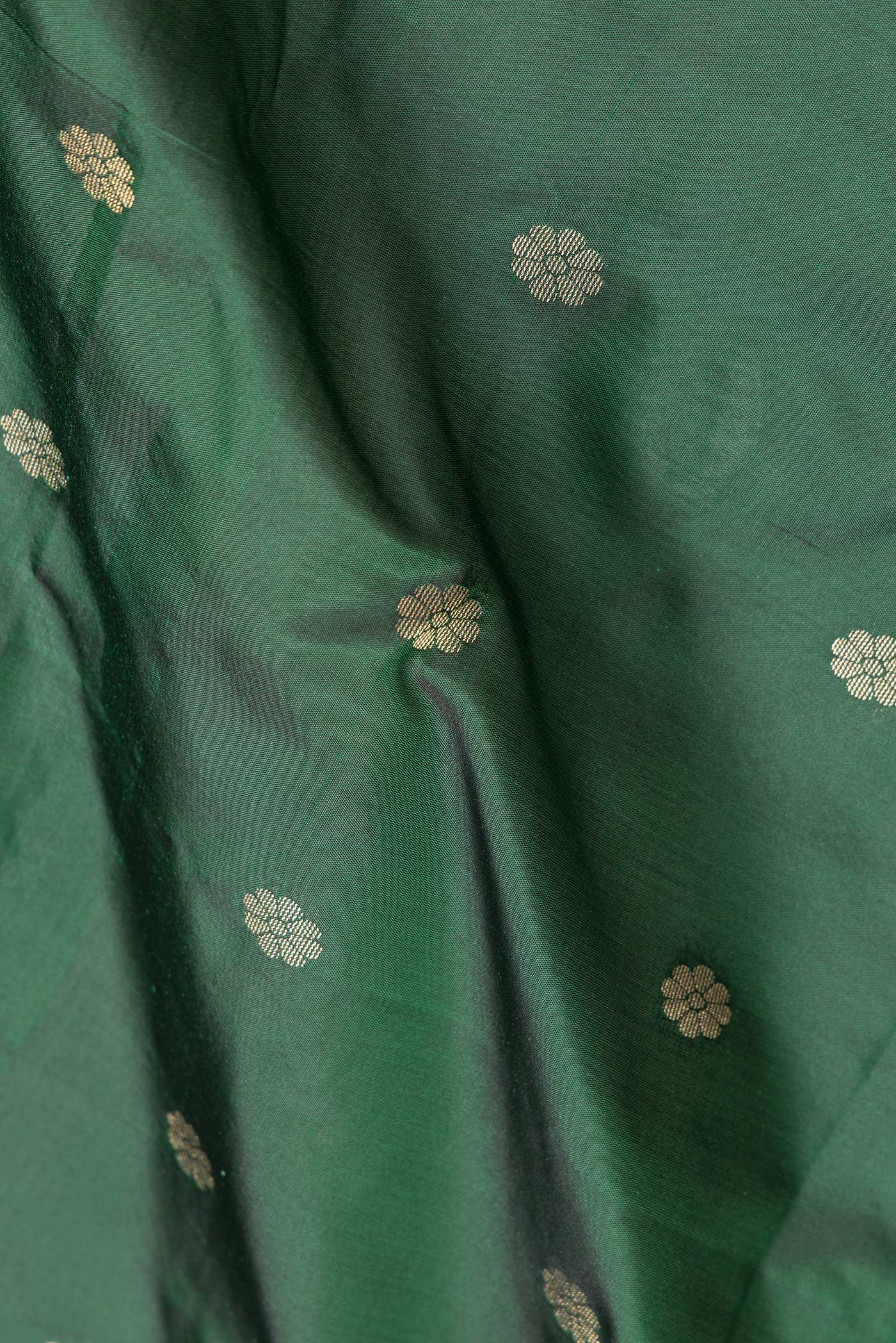 Close up of Bottle Green Dual Tone Blended Paithani Silk Saree with Zari Butta on the body and Zari Border.  displaying folds