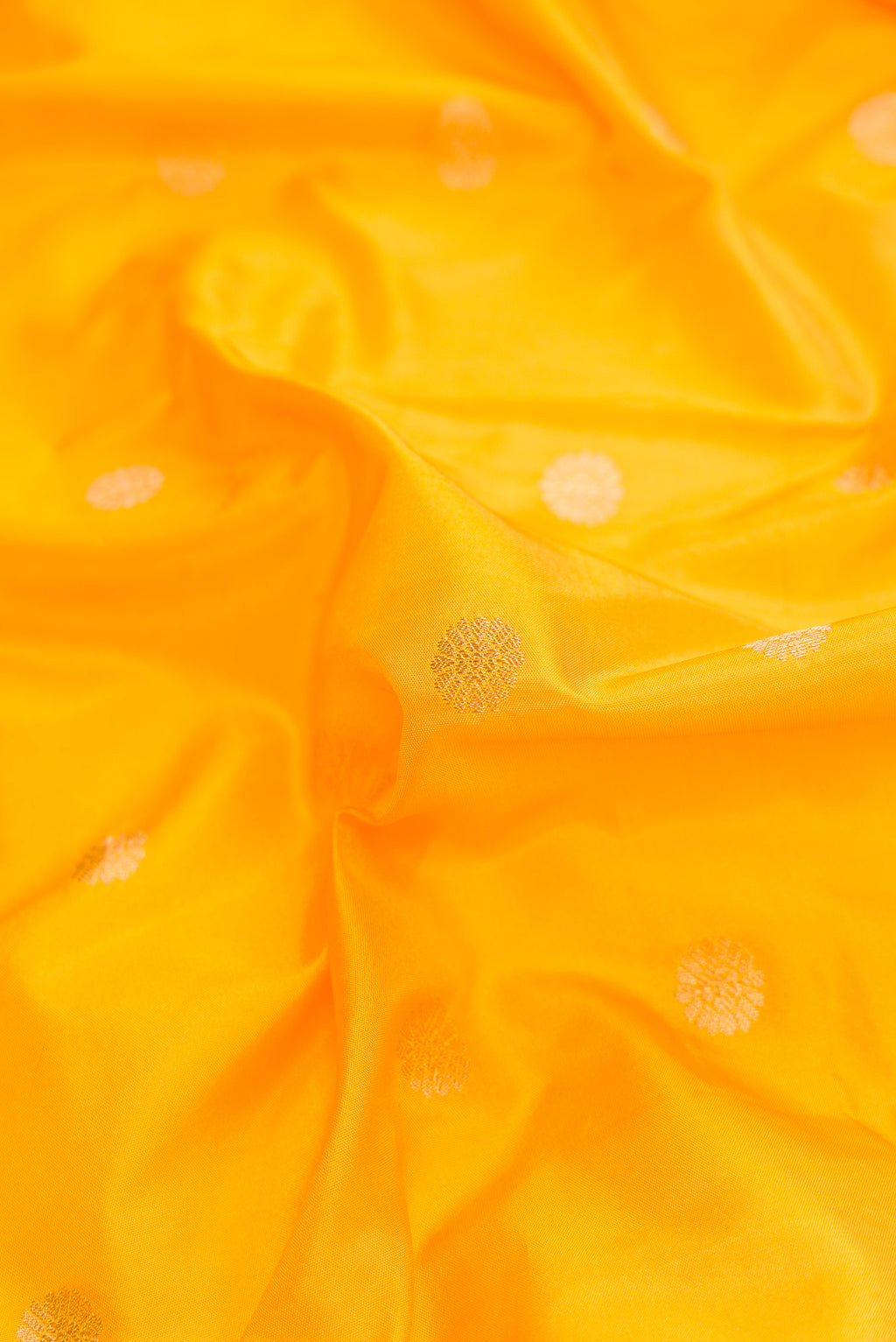 Close up of Yellow Dual Tone Blended Paithani Silk Saree with Zari Butta on the body and Zari Border.  displaying folds