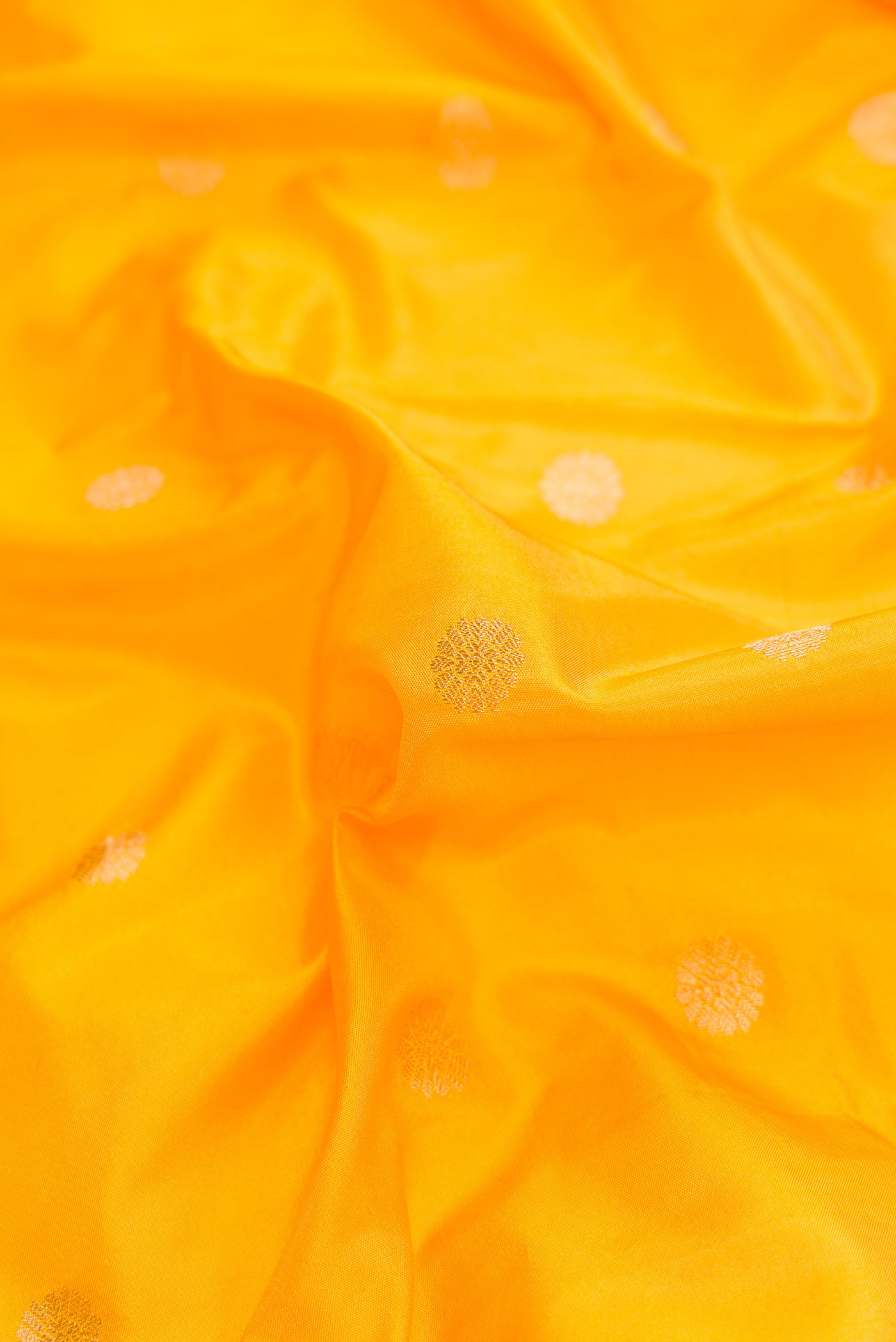 Close up of Yellow Dual Tone Blended Paithani Silk Saree with Zari Butta on the body and Zari Border.  displaying folds