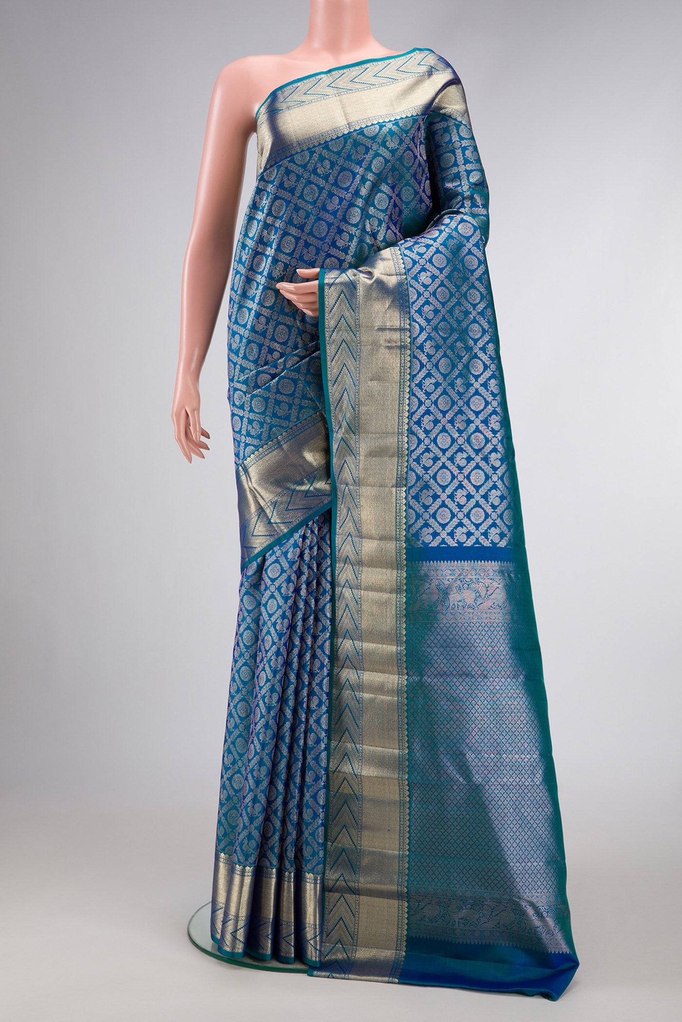 Peacock Blue Dual Tone Kanchipuram Silk Saree with Zari Brocade on the body and Zari Border.  displayed on a mannequin