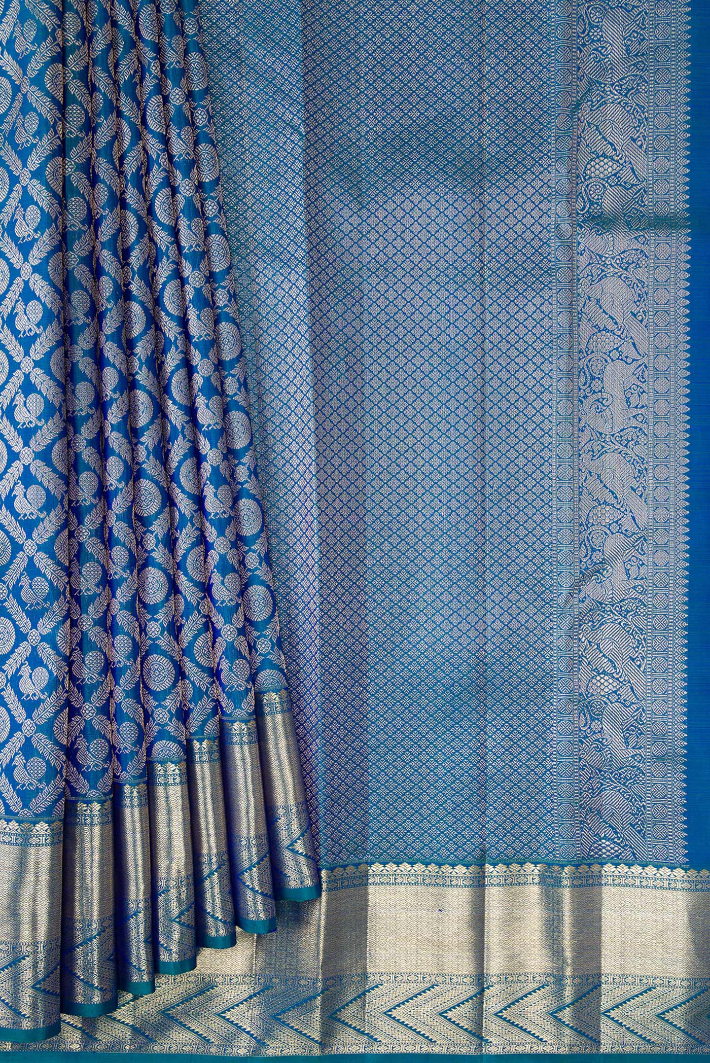 Pleats and pallu of Peacock Blue Dual Tone Kanchipuram Silk Saree with Zari Brocade on the body and Zari Border. 