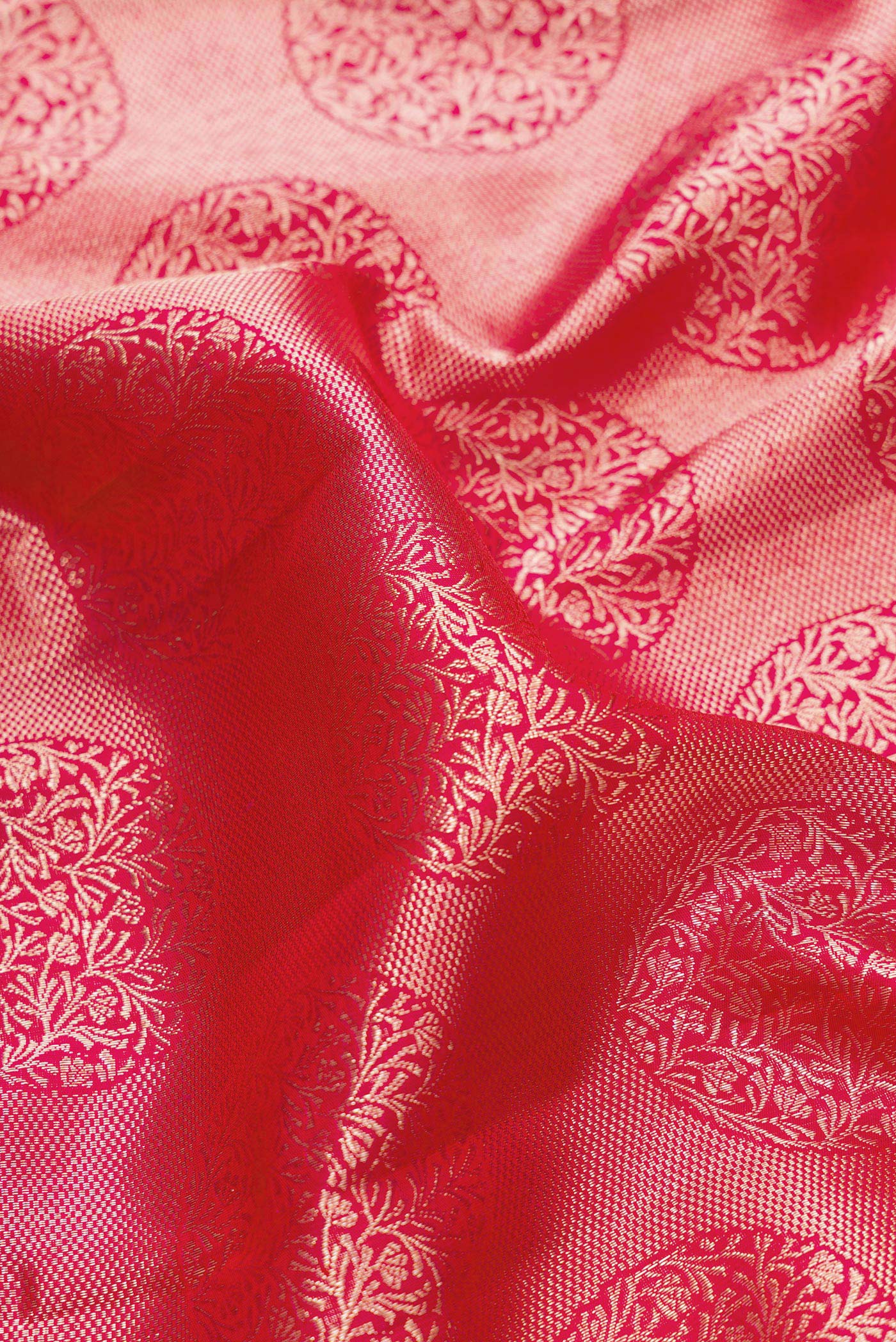 Close up of Pink Dual Tone Kanchipuram Silk Saree with Zari Brocade on the body and Zari Border.  displaying folds