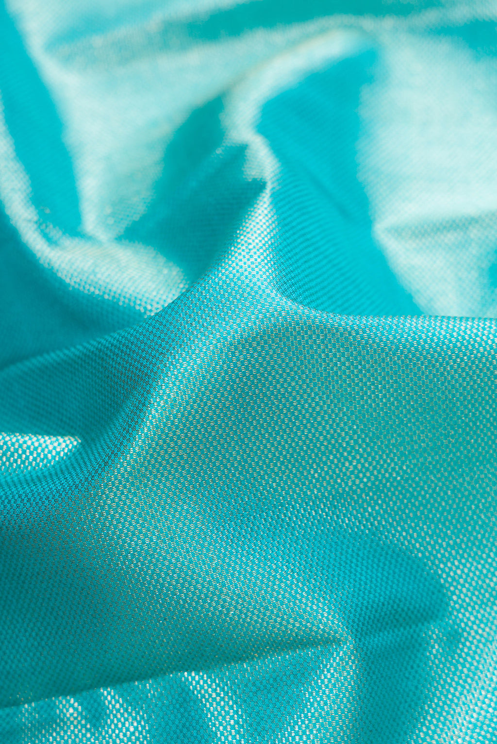 Close up of Sky Blue Dual Tone Kanchipuram Silk Saree with Zari Brocade on the body and Zari Border.  displaying folds