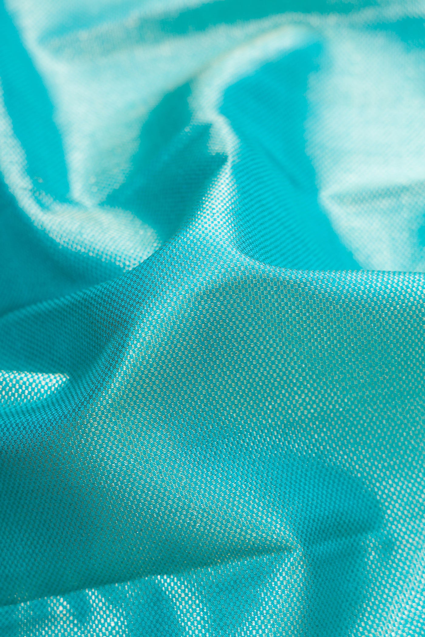 Close up of Sky Blue Dual Tone Kanchipuram Silk Saree with Zari Brocade on the body and Zari Border.  displaying folds