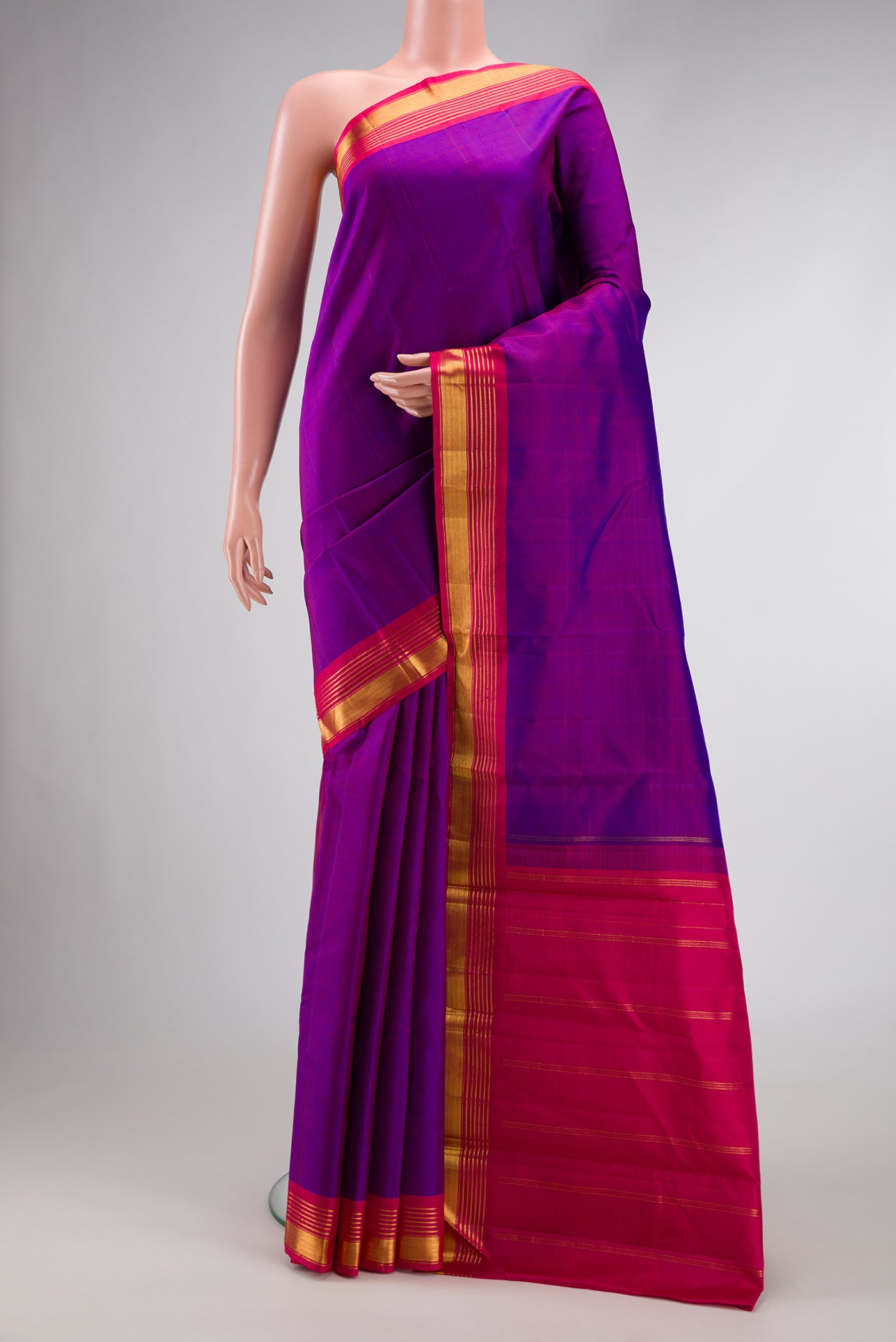 Purple Dual Tone Kanjivaram Silk Saree with Plain Body and Zari Border.  displayed on a mannequin