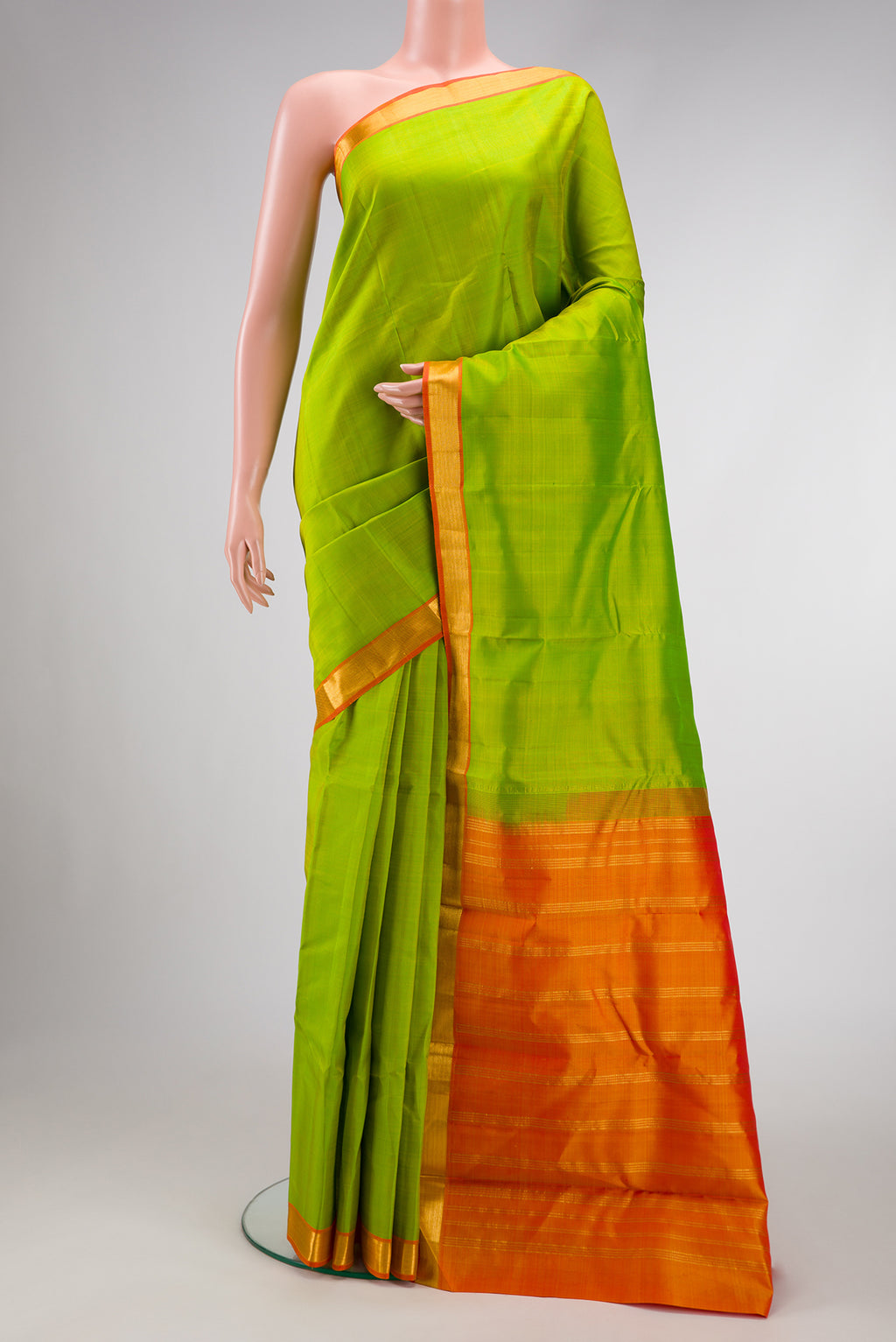 Parrot Green Dual Tone Kanjivaram Silk Saree with Plain Body and Zari Border.  displayed on a mannequin