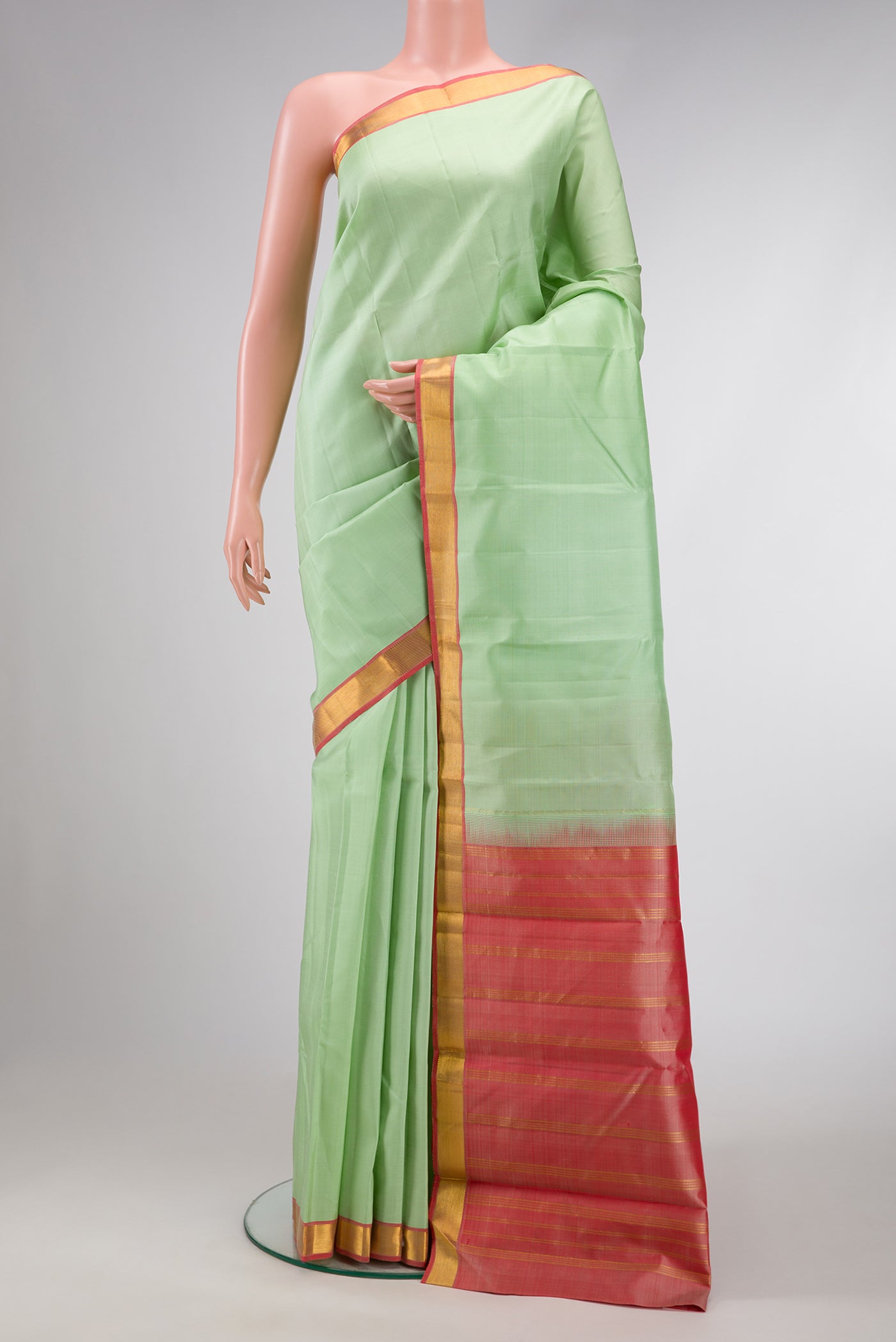 Pista Green Dual Tone Kanjivaram Silk Saree with Plain Body and Zari Border.  displayed on a mannequin