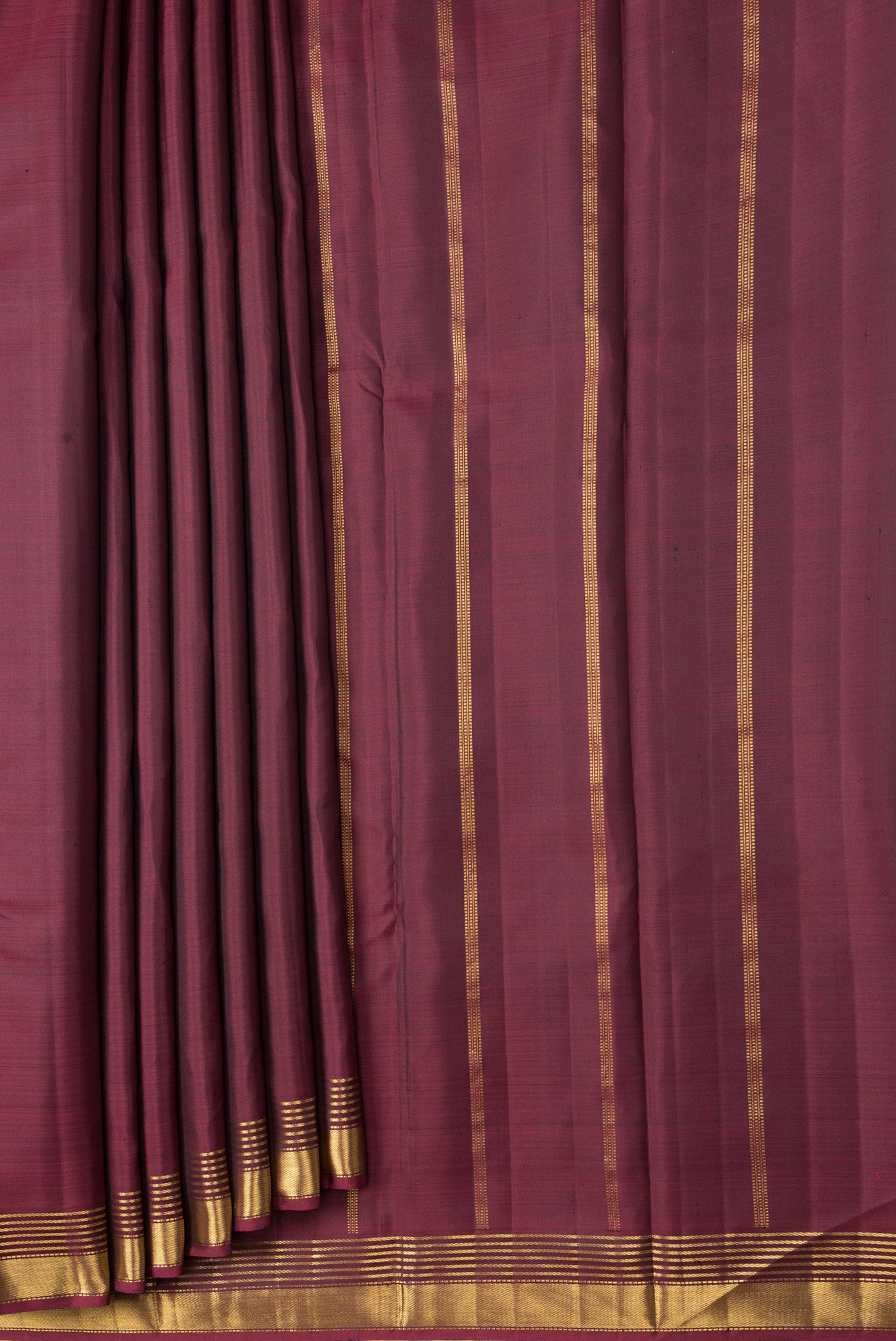 Pleats and pallu of Maroon Dual Tone Kanjivaram Silk Saree with Plain Body and Zari Border. 