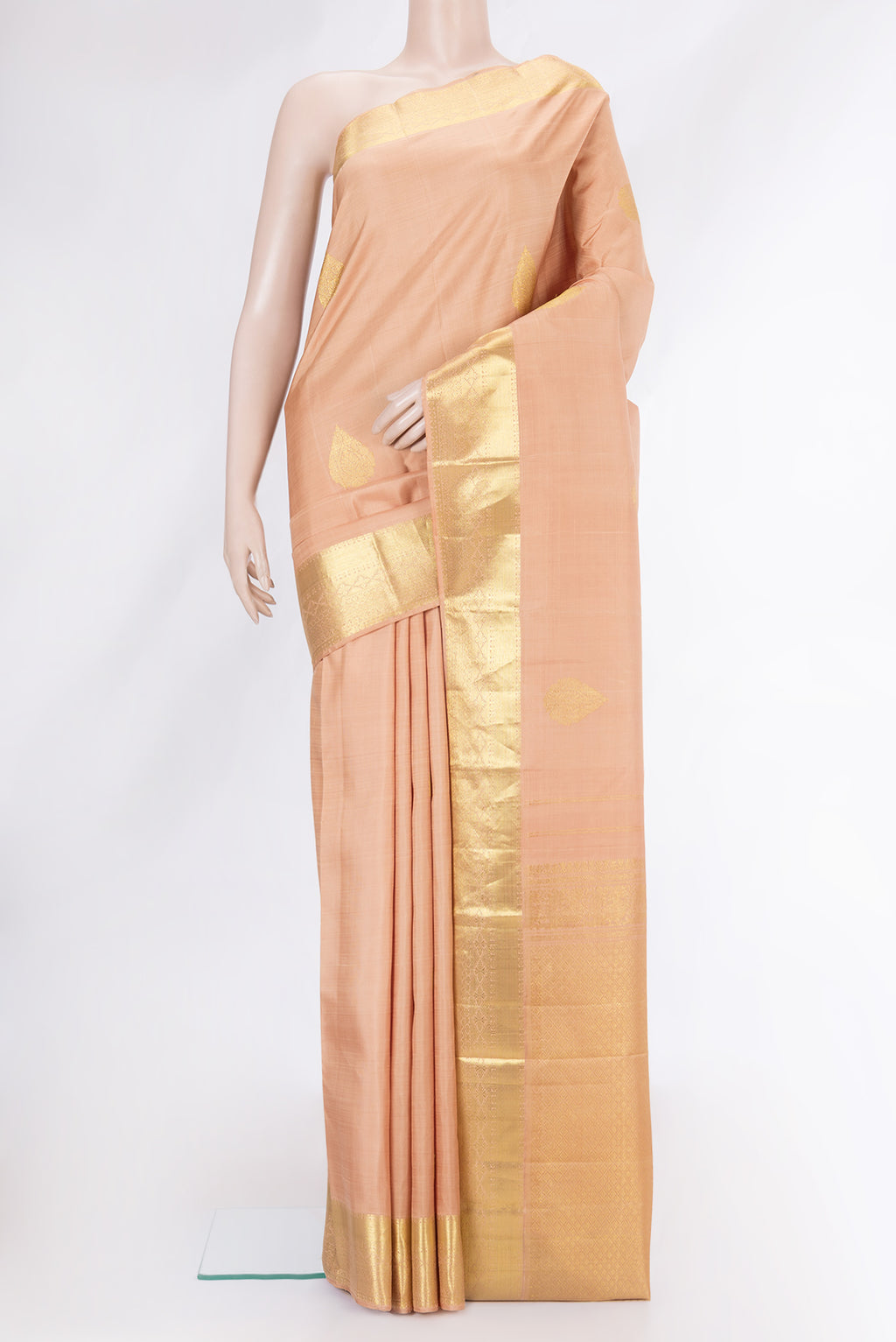 Golden Peach Dual Tone Kanjivaram Silk Saree with Zari Butta on the body and Zari Border.  displayed on a mannequin
