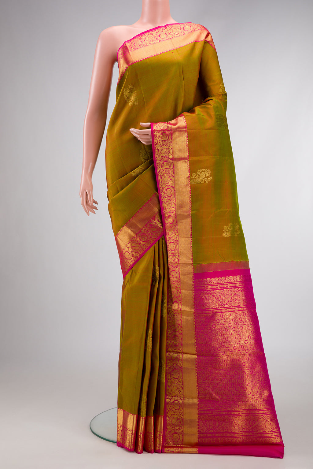 Mehandi Green Dual Tone Kanjivaram Silk Saree with Zari Butta on the body and Zari Border.  displayed on a mannequin