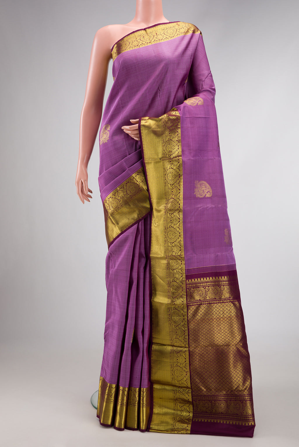 Lavender Dual Tone Kanjivaram Silk Saree with Zari Butta on the body and Zari Border.  displayed on a mannequin