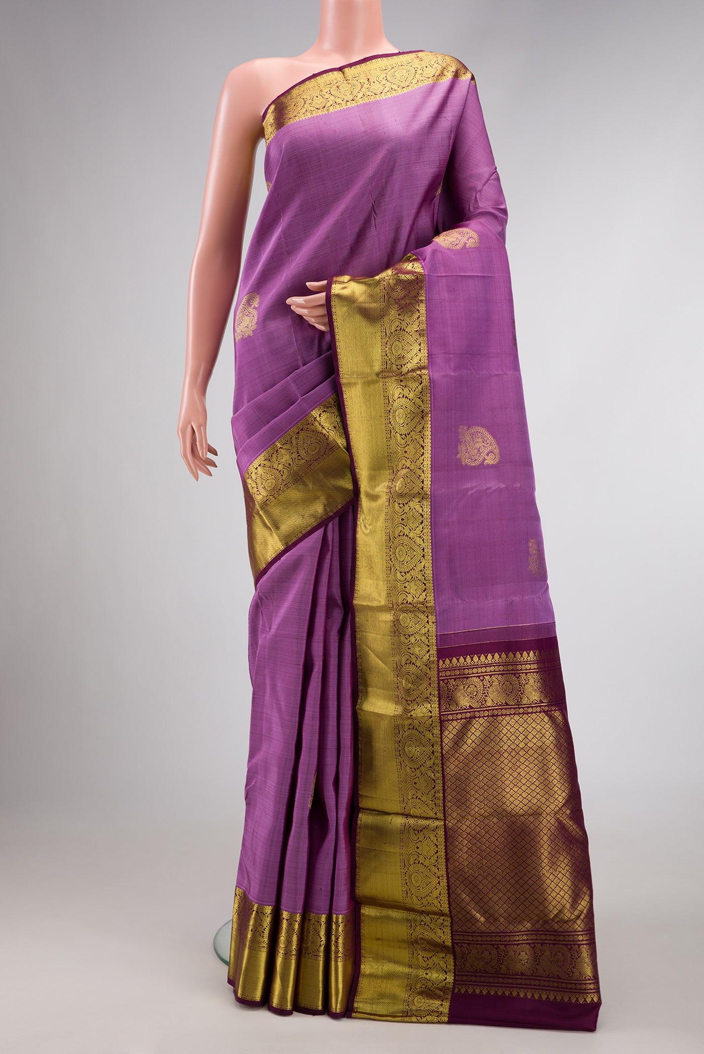 Lavender Dual Tone Kanjivaram Silk Saree with Zari Butta on the body and Zari Border.  displayed on a mannequin