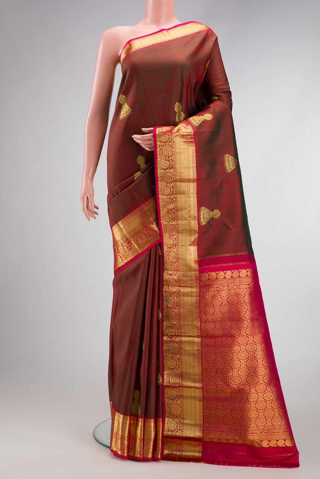 Maroon Dual Tone Kanjivaram Silk Saree with Zari Butta on the body and Zari Border.  displayed on a mannequin