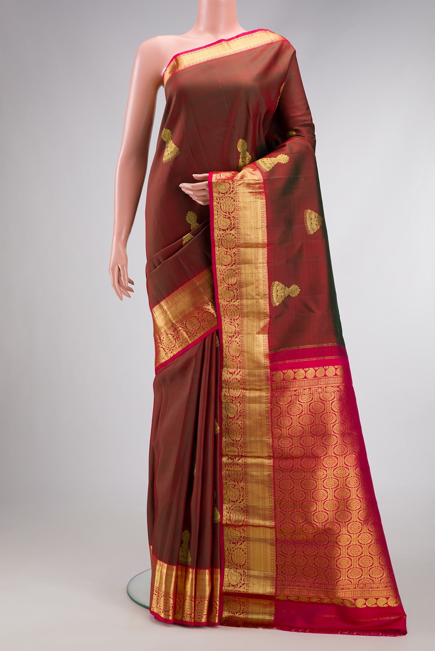 Maroon Dual Tone Kanjivaram Silk Saree with Zari Butta on the body and Zari Border.  displayed on a mannequin