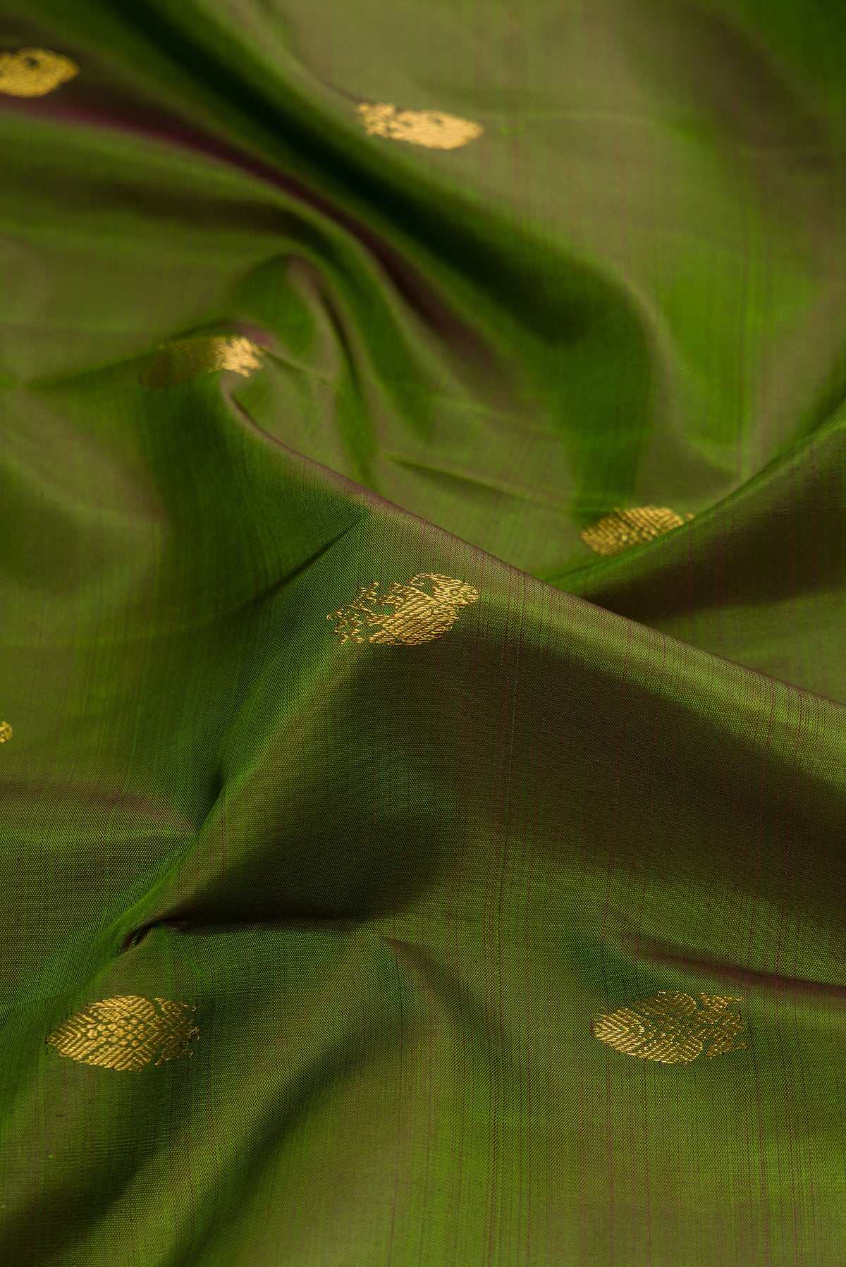 Close up of Mehandi Green Dual Tone Kanjivaram Silk Saree with Zari Butta on the body and Zari Border.  displaying folds