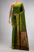 Green Dual Tone Kanjivaram Silk Saree with Zari Butta on the body and Zari Border.  displayed on a mannequin