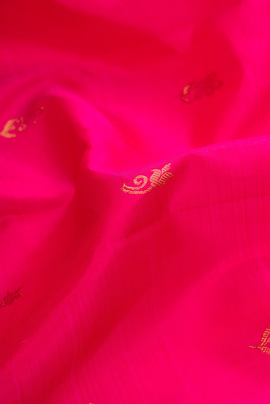 Close up of Pink Dual Tone Kanjivaram Silk Saree with Zari Butta on the body and Zari Border.  displaying folds