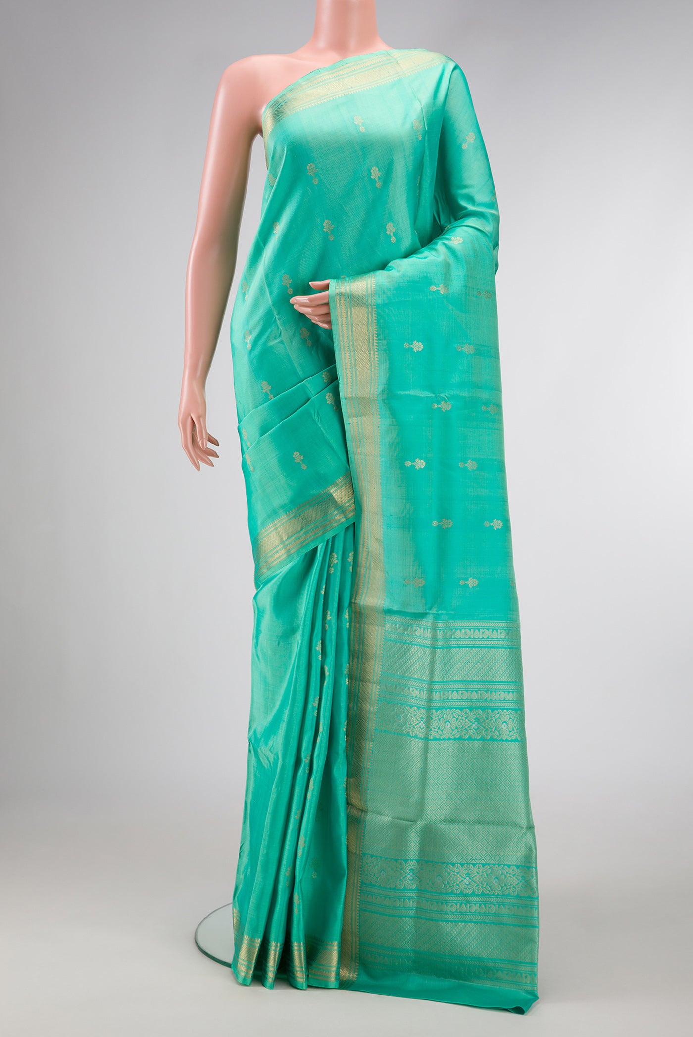 Green Dual Tone Soft Silk Saree with Zari Butta on the body and Zari Border.  displayed on a mannequin