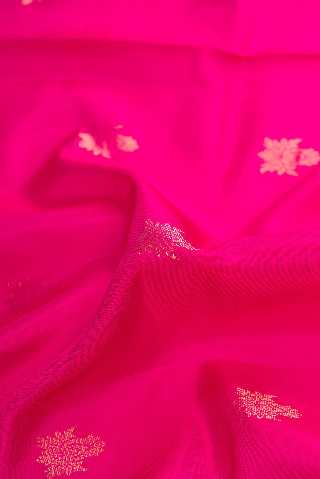 Close up of Pink Dual Tone Soft Silk Saree with Zari Butta on the body and Zari Border.  displaying folds