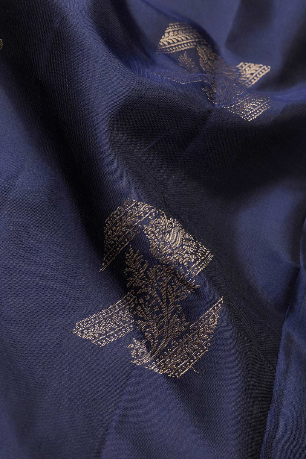 Close up of Navy Blue Dual Tone Soft Silk Saree with Zari Butta on the body and Without Border.  displaying folds