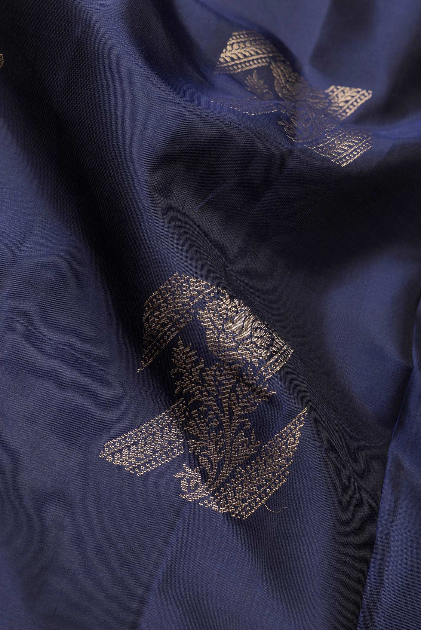 Close up of Navy Blue Dual Tone Soft Silk Saree with Zari Butta on the body and Without Border.  displaying folds