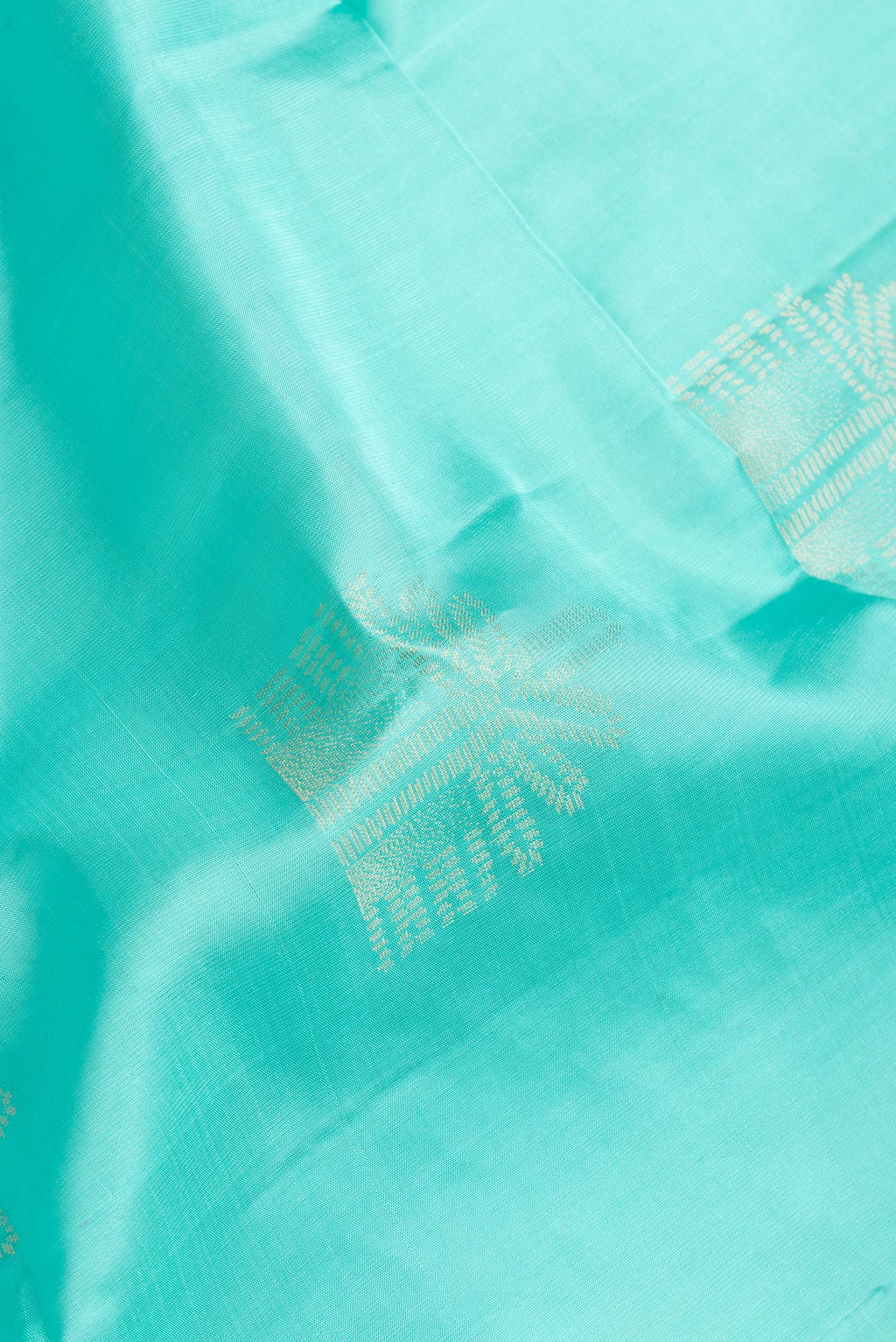 Close up of Sky Blue Dual Tone Soft Silk Saree with Zari Butta on the body and Without Border.  displaying folds
