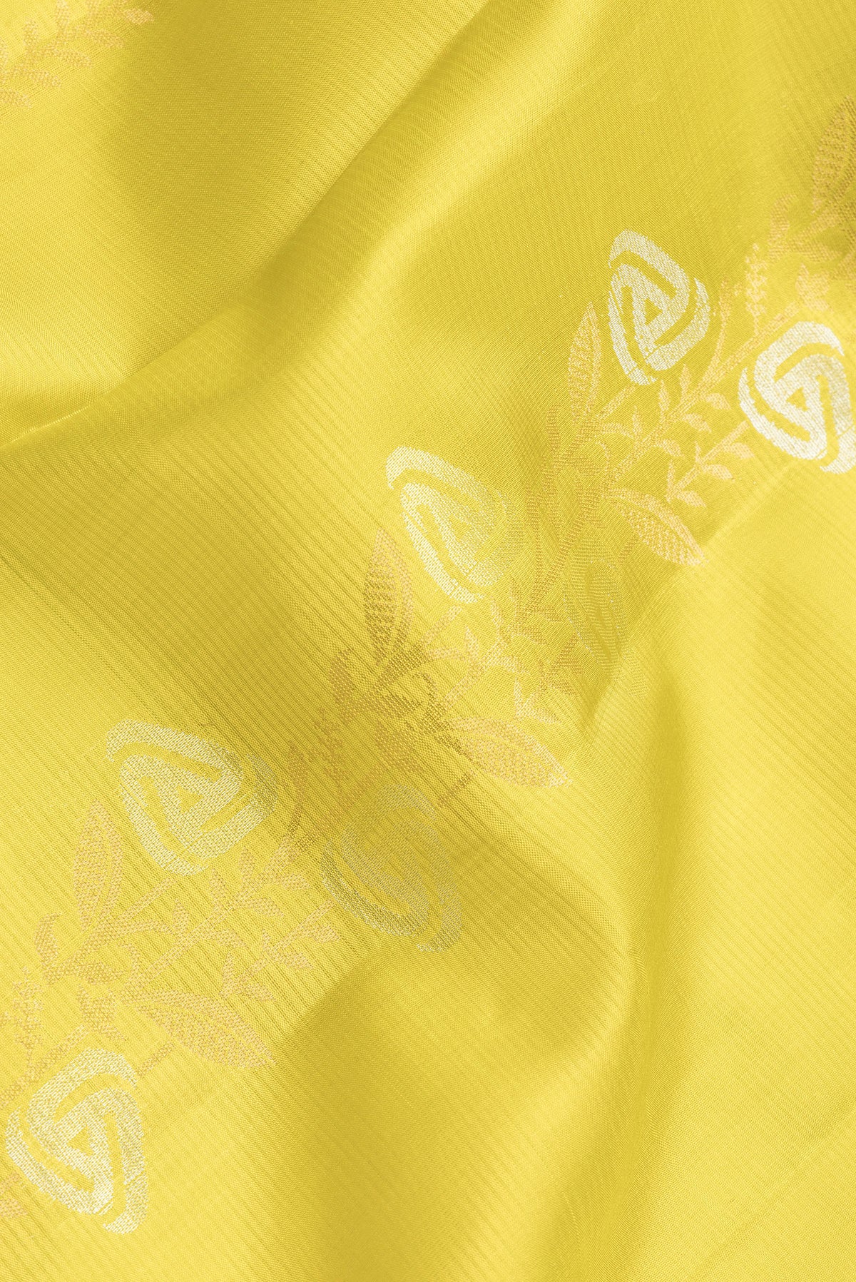 Close up of Parrot Green Dual Tone Soft Silk Saree with Zari Butta on the body and Zari Border.  displaying folds